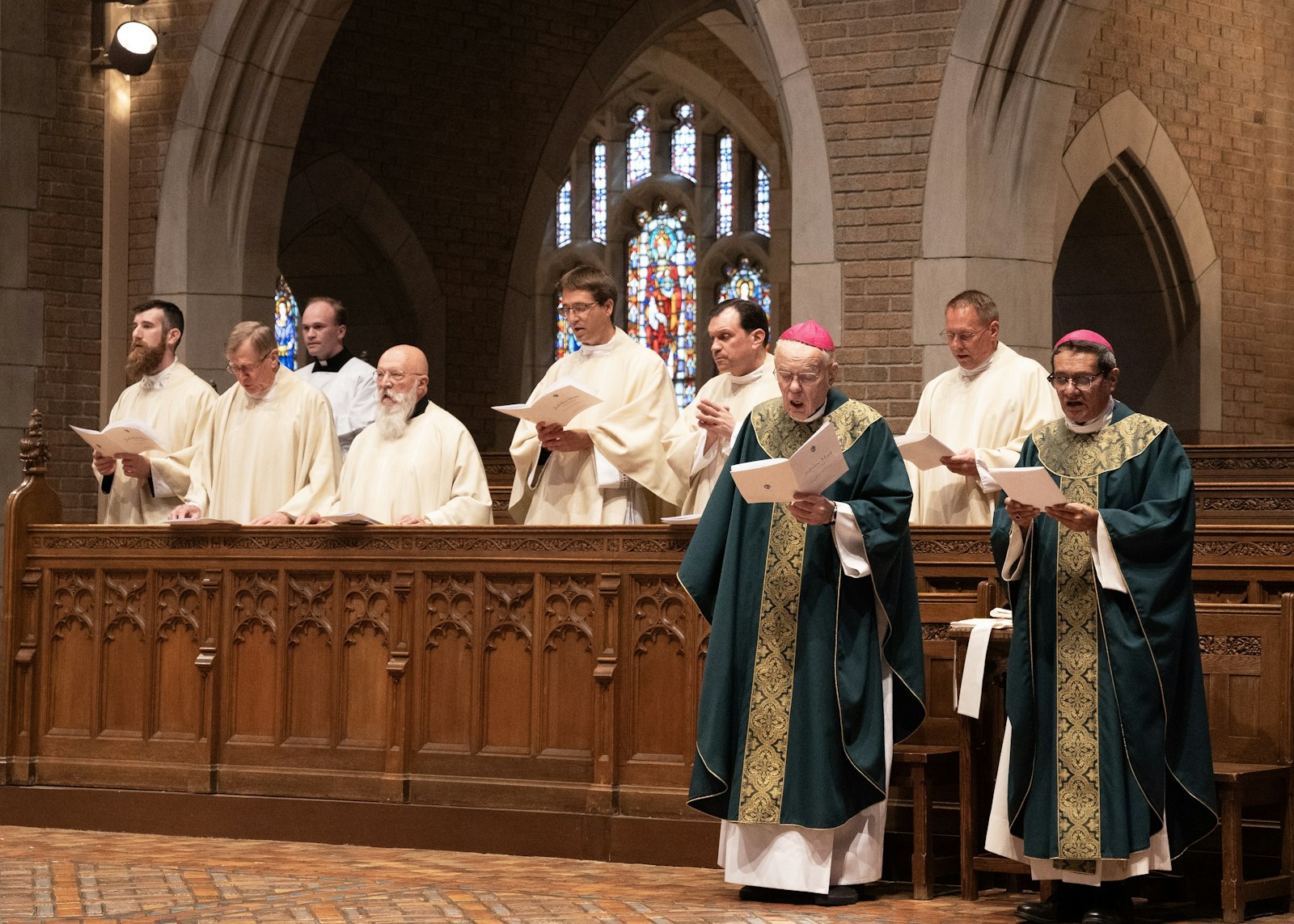 Bishops Donald F. Hanchon and Arturo Cepeda, right, sing alongside priests in choir inside Sacred Heart's chapel. In addition to Bishop Hanchon, who is celebrating his 50th jubilee, another Detroit bishop, Bishop Jeffrey M. Monforton, was among those celebrating 30 years.