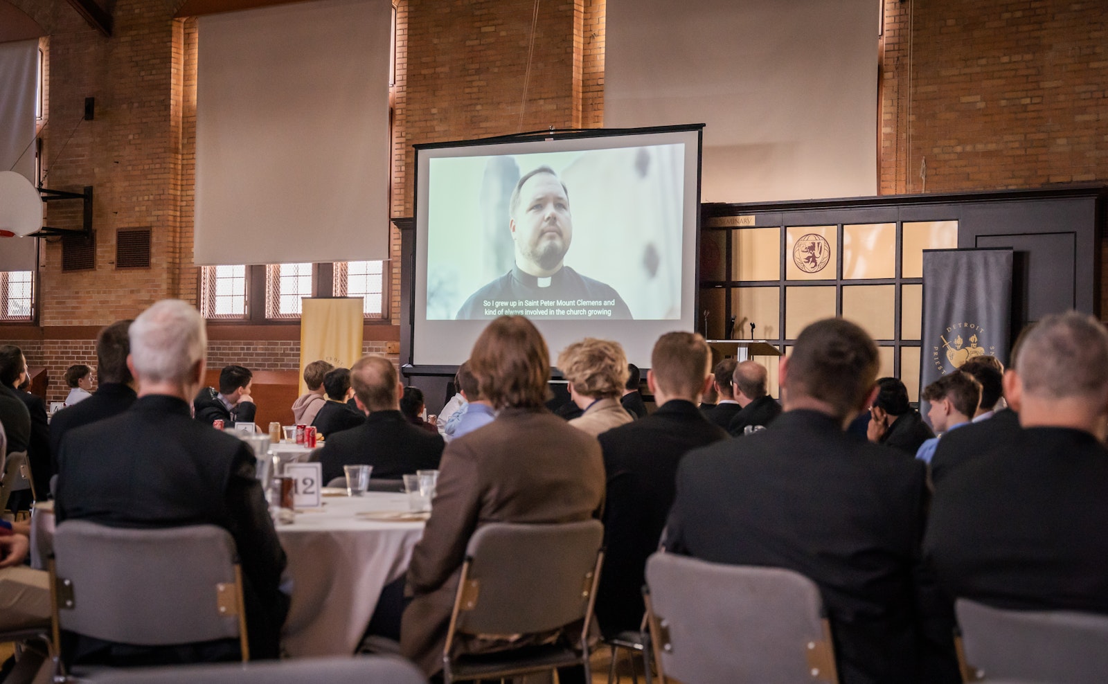 Discerners watch a video produced for the Office of Priestly Vocations during a discernment day at Sacred Heart Major Seminary in Detroit on March 28.