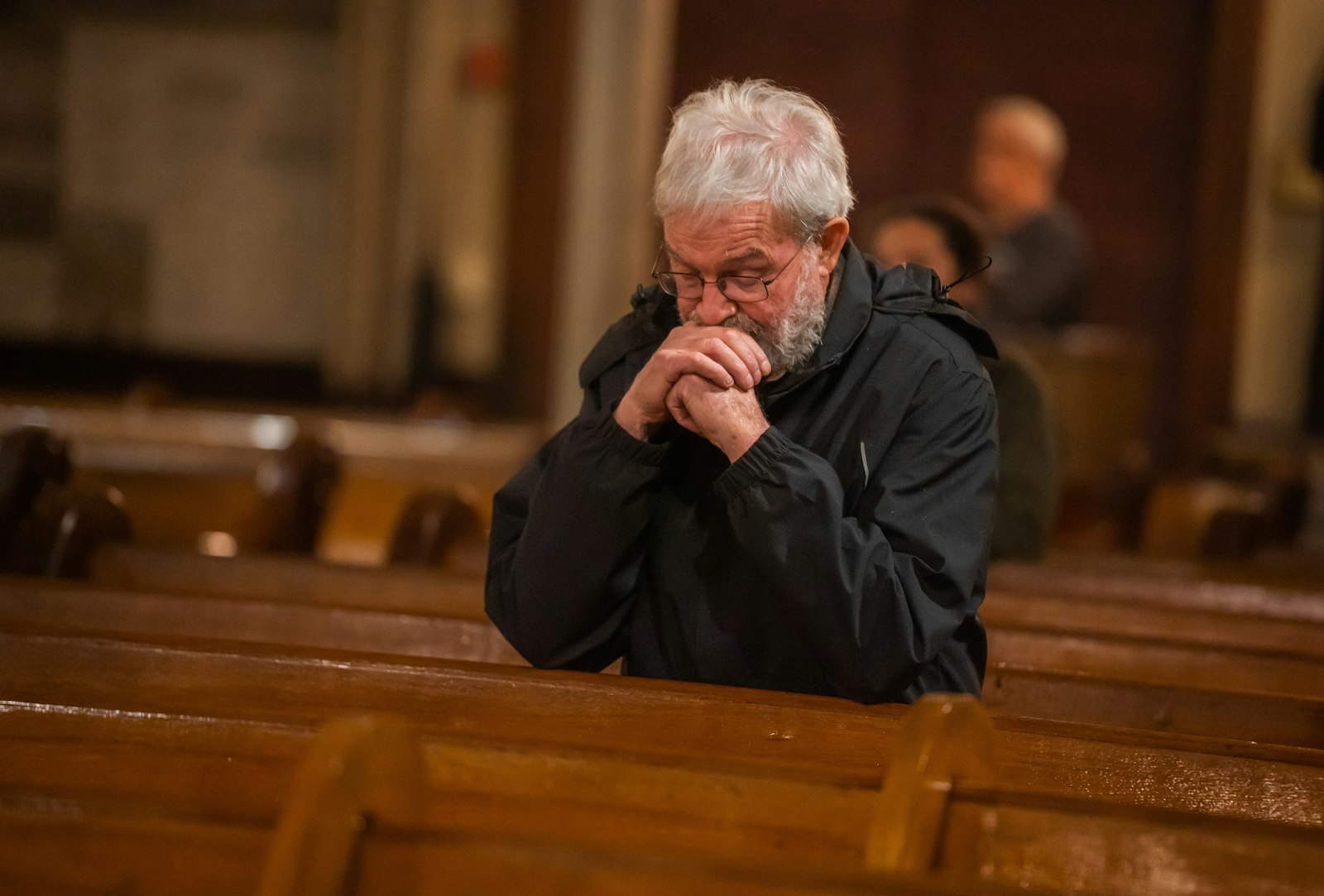 A man kneels in prayer at Old St. Mary's Parish in downtown Detroit's Greektown during an I AM HERE holy hour Dec. 8.