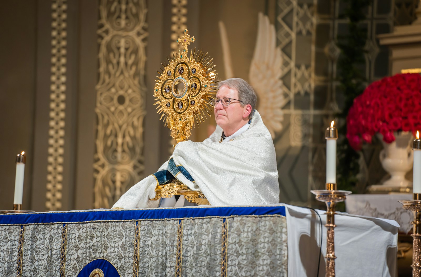 Deacon Mike Van Dyke holds the monstrance containing the Blessed Sacrament during an I AM HERE holy hour Dec. 8 at Old St. Mary's Parish in downtown Detroit's Greektown.