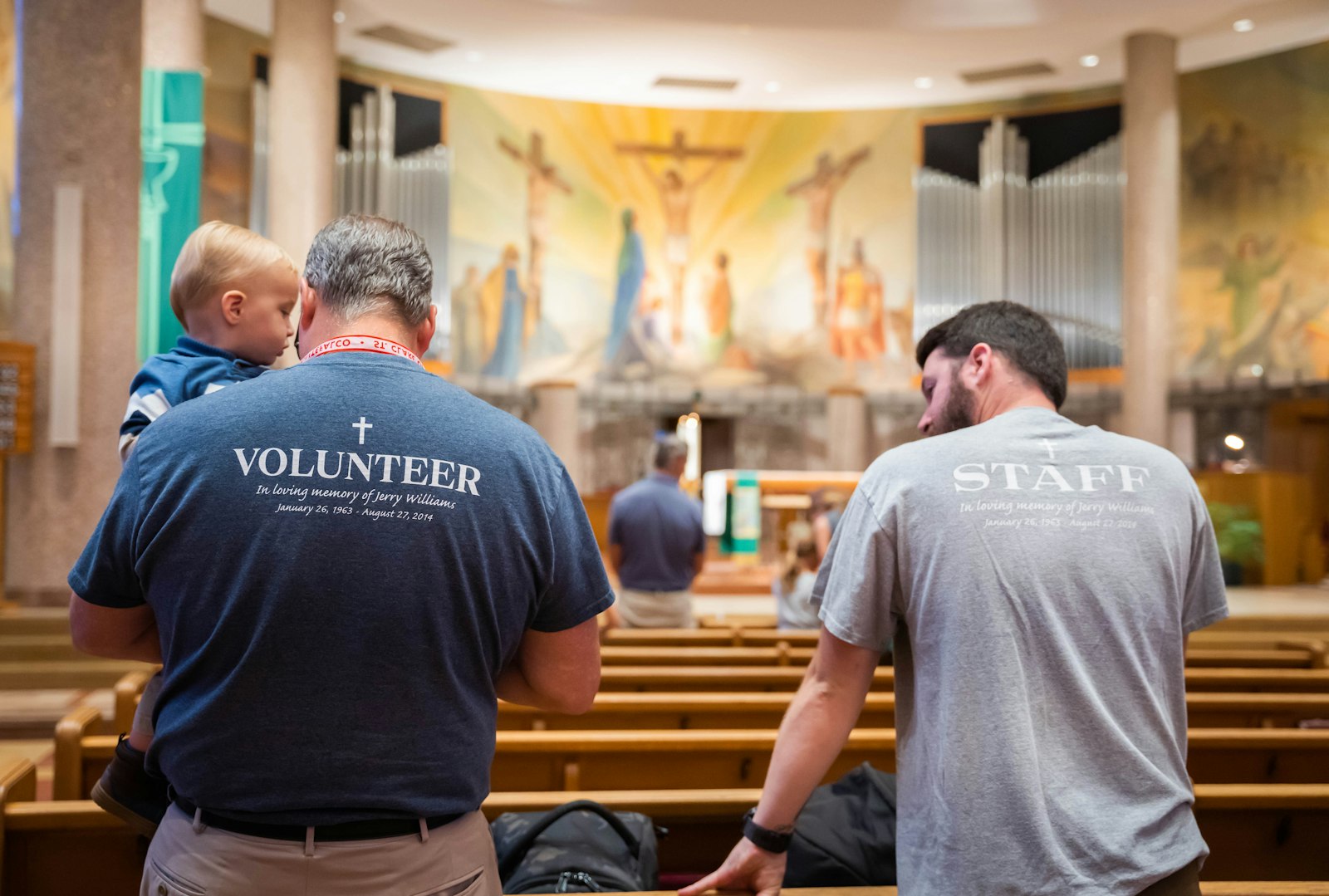 Project Hope of Michigan volunteers stand during Mass at St. Clare of Montefalco Parish in Grosse Pointe Park on Aug. 28. Amy Fox, who began Project Hope in 2014 in honor of her late uncle, Jerry Williams, said she's happy to see the parish embrace the effort year after year. (Valaurian Waller | Detroit Catholic)