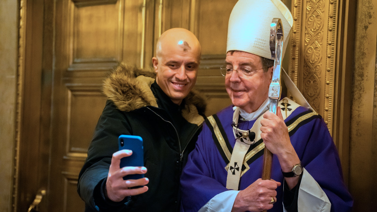 A Massgoer snaps a selfie with Archbishop Vigneron after Ash Wednesday Mass on Feb. 27, 2020, at St. Aloysius Parish in downtown Detroit. (Valaurian Waller | Detroit Catholic)