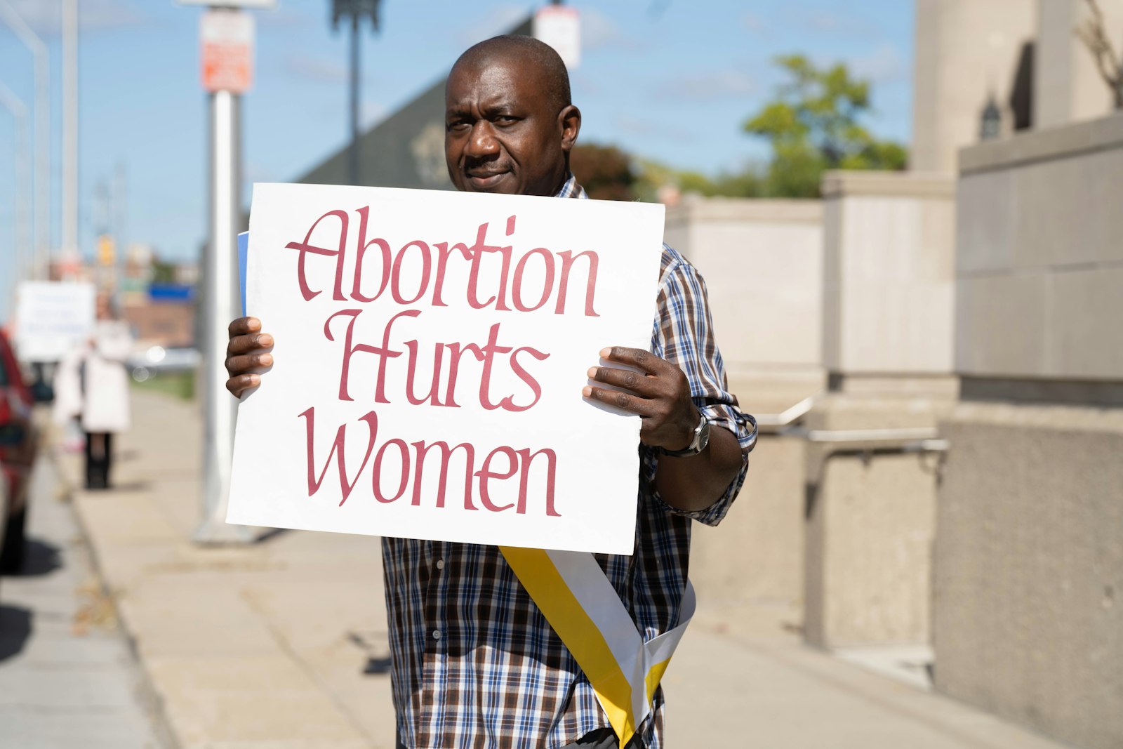 A man holds a sign while participating in a Life Chain outside the Cathedral of the Most Blessed Sacrament on Respect Life Sunday, Oct. 2. The Catholic Church is mobilizing against the "vast and extreme" Proposal 3, which would eliminate virtually all pro-life laws in the state and enshrine abortion as a constitutional right, even for minors without parental consent. (Valaurian Waller | Detroit Catholic)