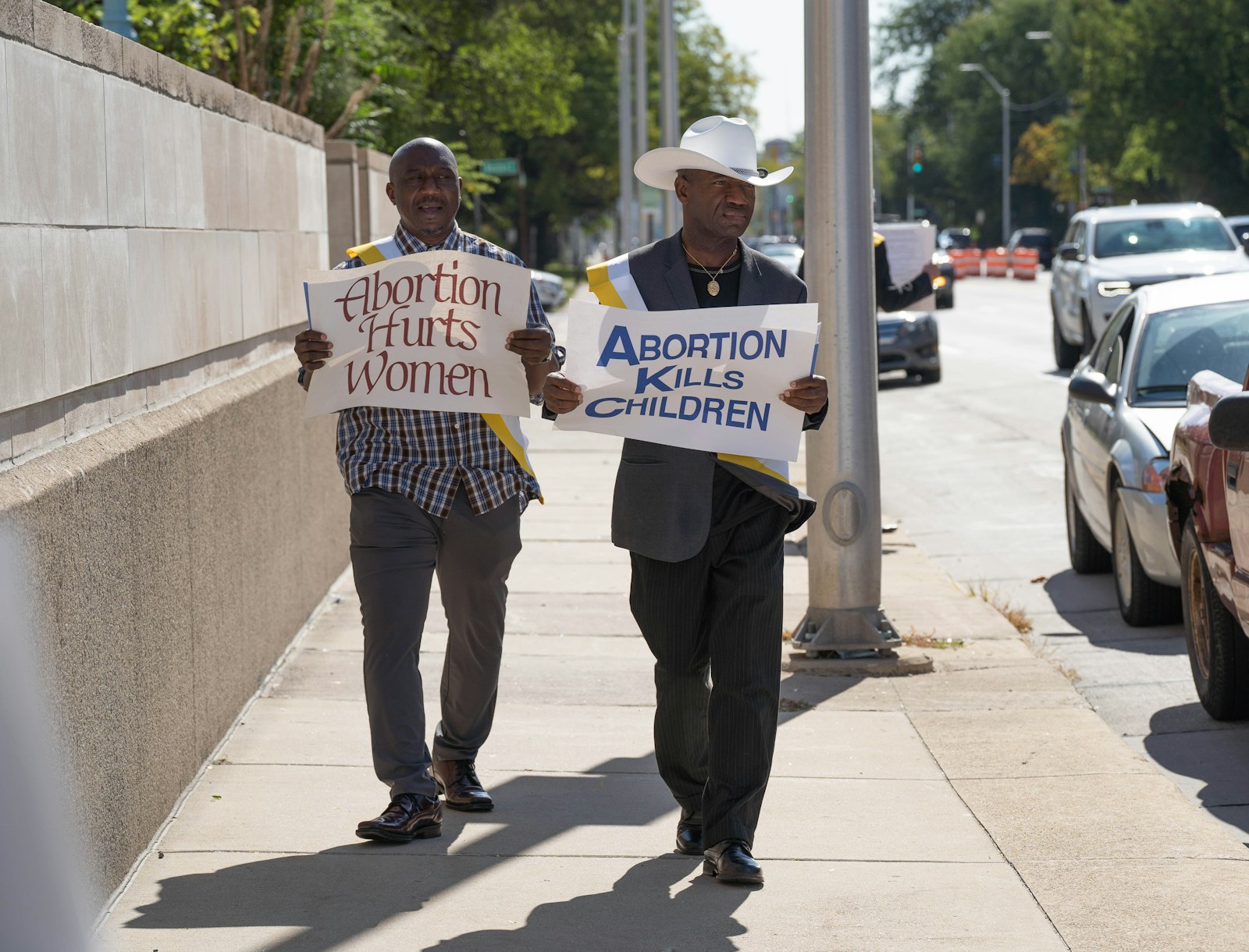 People hold signs outside the Cathedral of the Most Blessed Sacrament on Oct. 2, Respect Life Sunday. After the Mass, Archbishop Vigneron and a handful of parishioners participated in a Life Chain along Woodward Avenue, holding signs saying "Abortion Hurts Women" and urging passersby to reject Proposal 3.