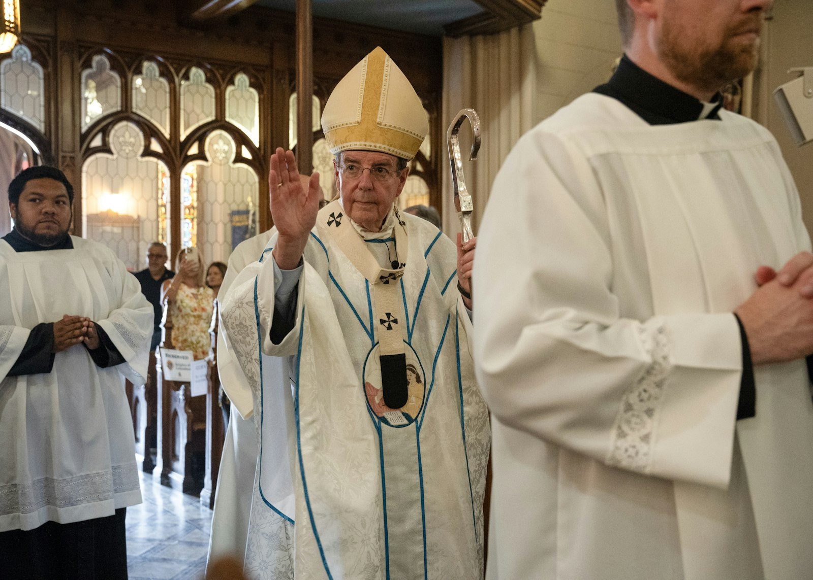 The archbishop blesses the faithful as he processes into the Basilica on the final day of the Ste. Anne novena.