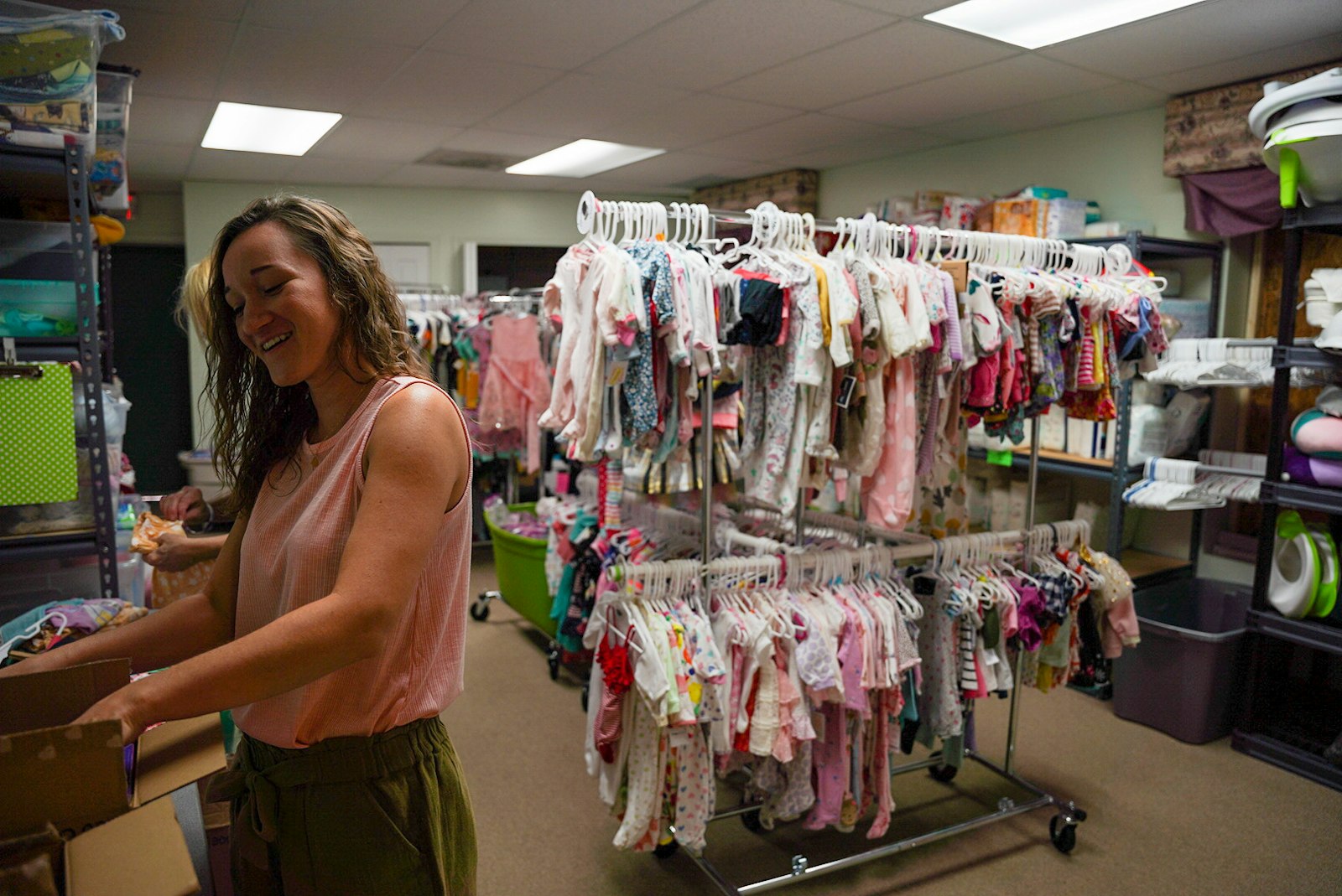 A worker sorts through items in the clothes closet at the Lennon Pregnancy Center in Dearborn Heights. Access to clothes closets is one of the many services that can be found through Walking With Moms in Need, in addition to financial assistance, adoption agencies, health care, food and formula assistance.