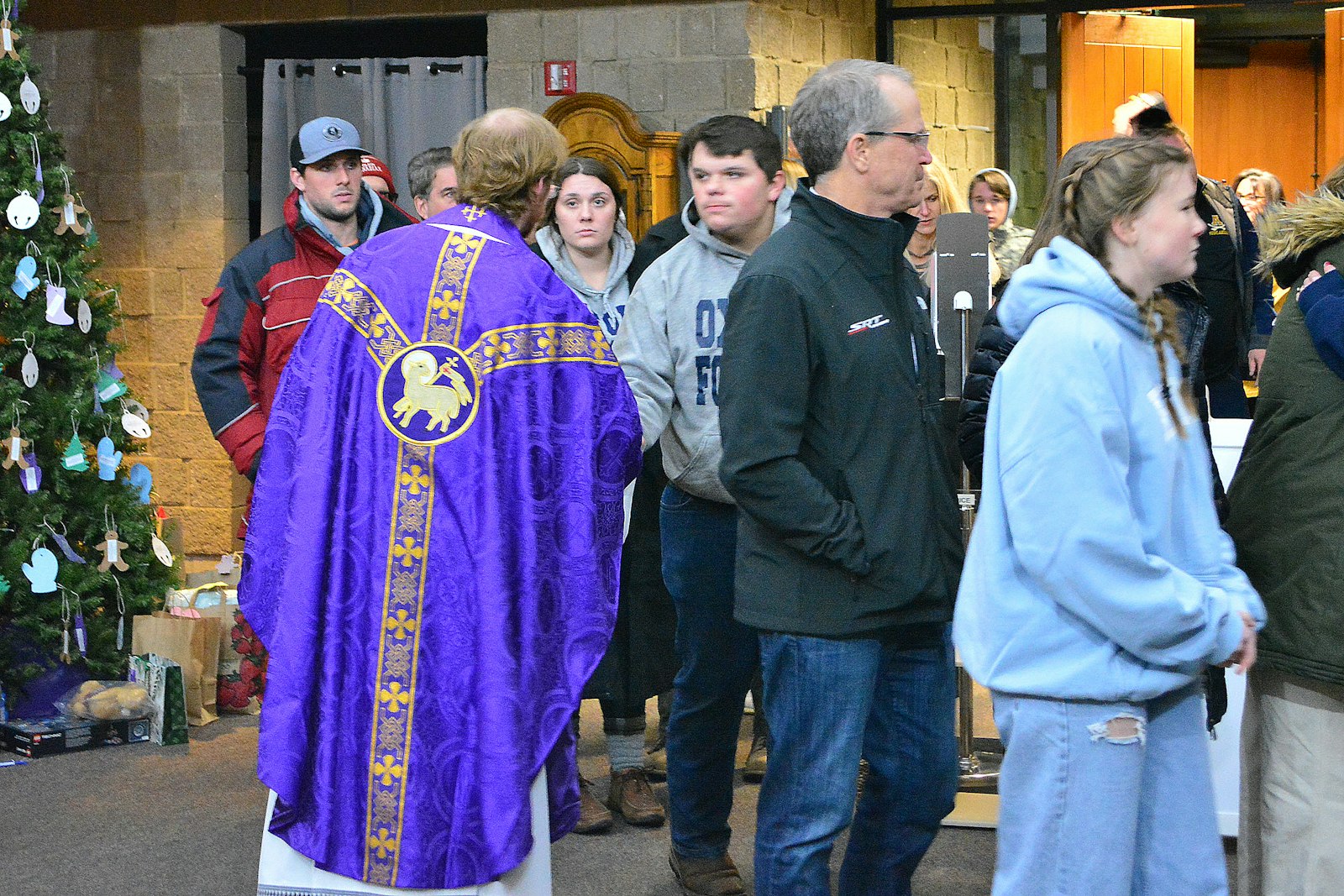 St. Joseph associate pastor Fr. John Carlin greets Oxford High School students, parents, alumni and community members Nov. 30 for a Mass of healing at the Lake Orion parish.