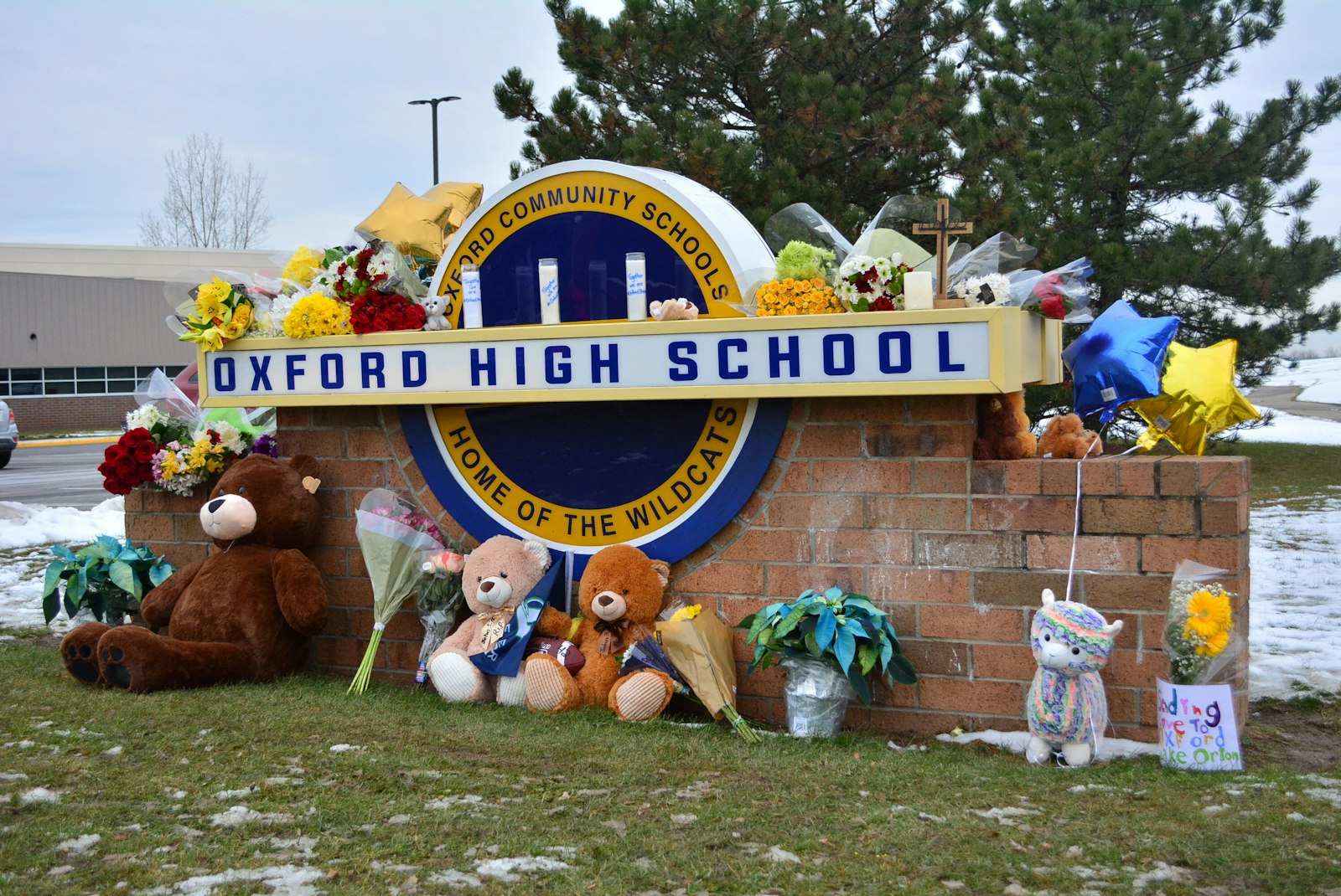 Stuffed animals, candles and balloons adorn the sign outside Oxford High School days after a mass shooting at the northern Oakland County school claimed four lives and injured seven others Nov. 30, 2021. (Michael Stechschulte | Detroit Catholic)