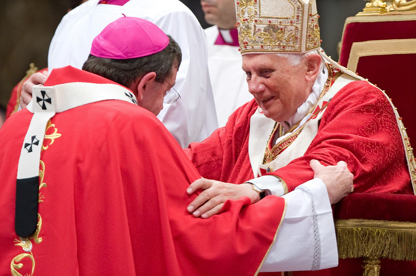 Pope Benedict XVI smiles as he places the pallium on the shoulders of Archbishop Allen H. Vigneron at St. Peter's Basilica on the Solemnity of SS. Peter and Paul, June 29, 2009. (CNS photo)