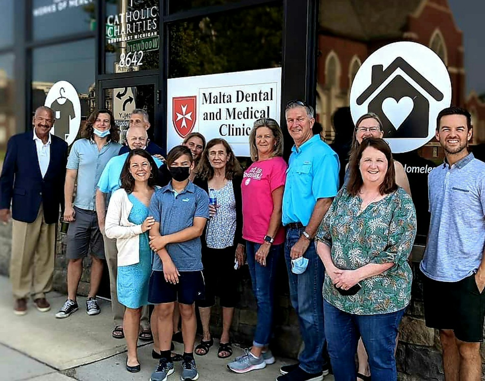 Angela Moloney, pictured front left (in blue), is seen with others at the newly established Center for the Works of Mercy on Woodward Avenue in Detroit. The center, sponsored by Catholic Charities of Southeast Michigan, helps low-income clients with a variety of material and spiritual needs.