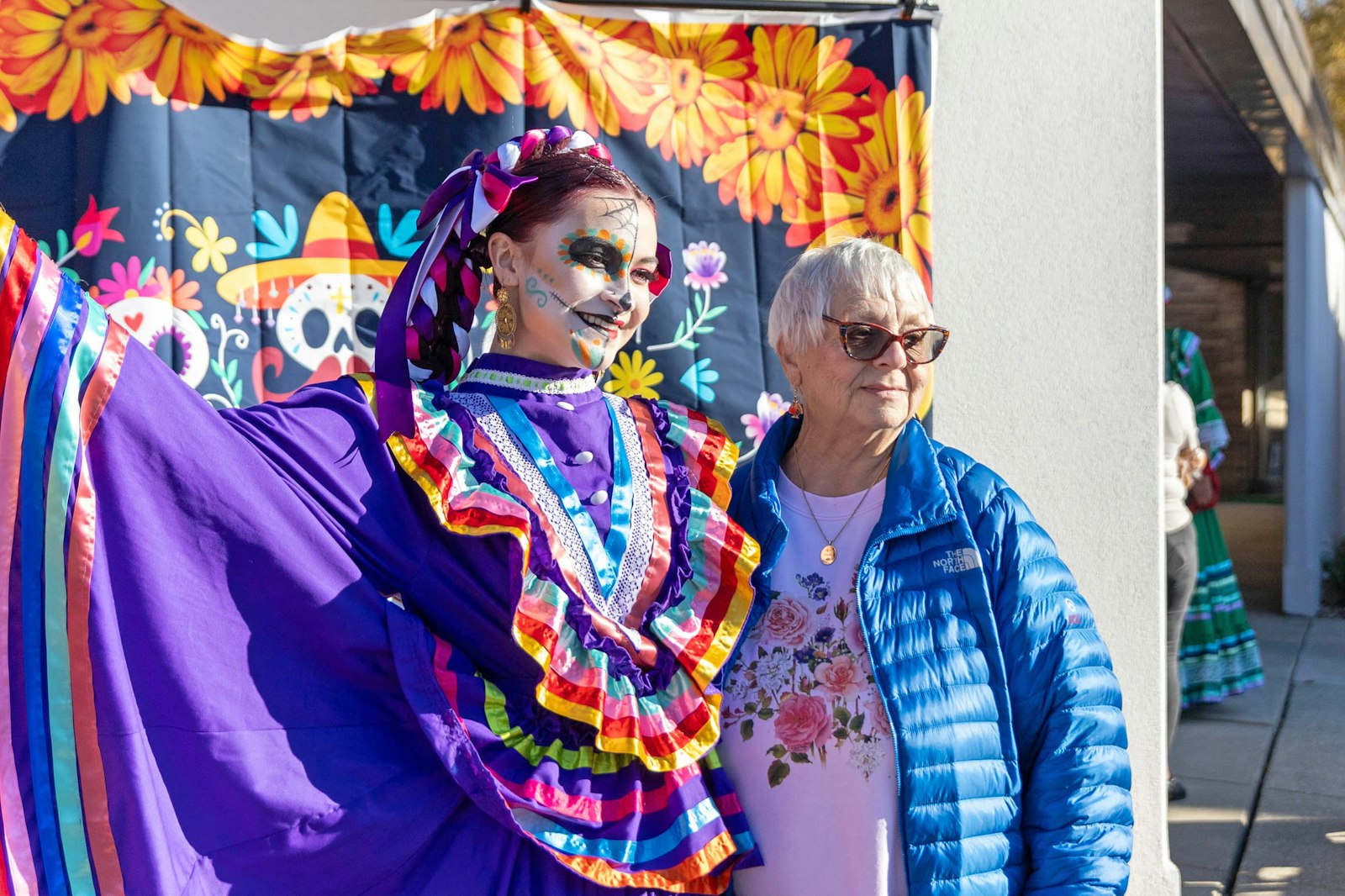 A young dancer poses for photographs at Our Lady of Hope Cemetery in Brownstown Township during Dia de los Muertos, which gathered dozens of families from around the area.