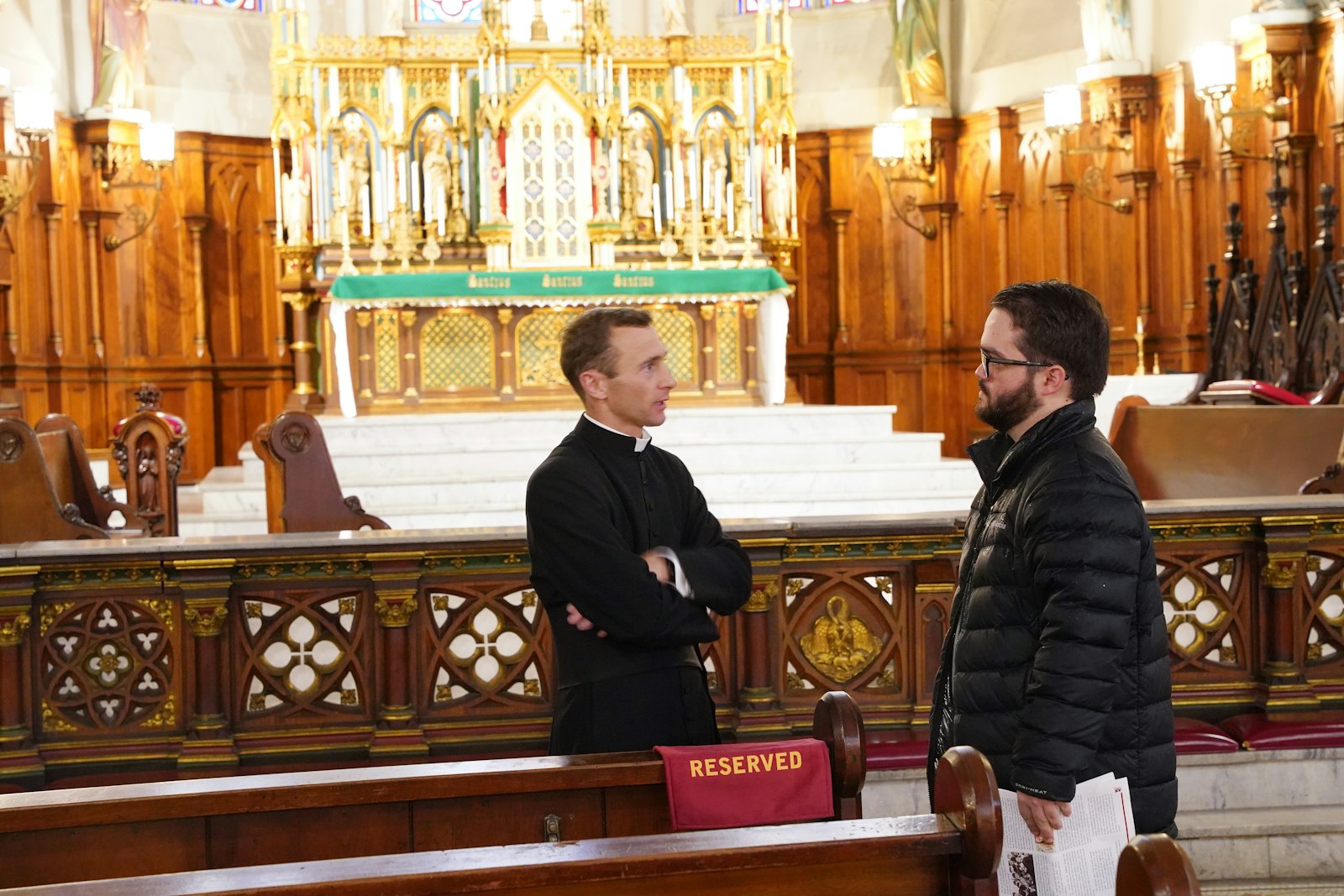 Canon Commins speaks to a reporter about the establishment of DeSales Park. Canon Commins thinks the establishment of the park not only gives the parish more room to grow, but serves as a beacon of hope for Detroit's lower east side. (Photo by Daniel Meloy | Detroit Catholic)