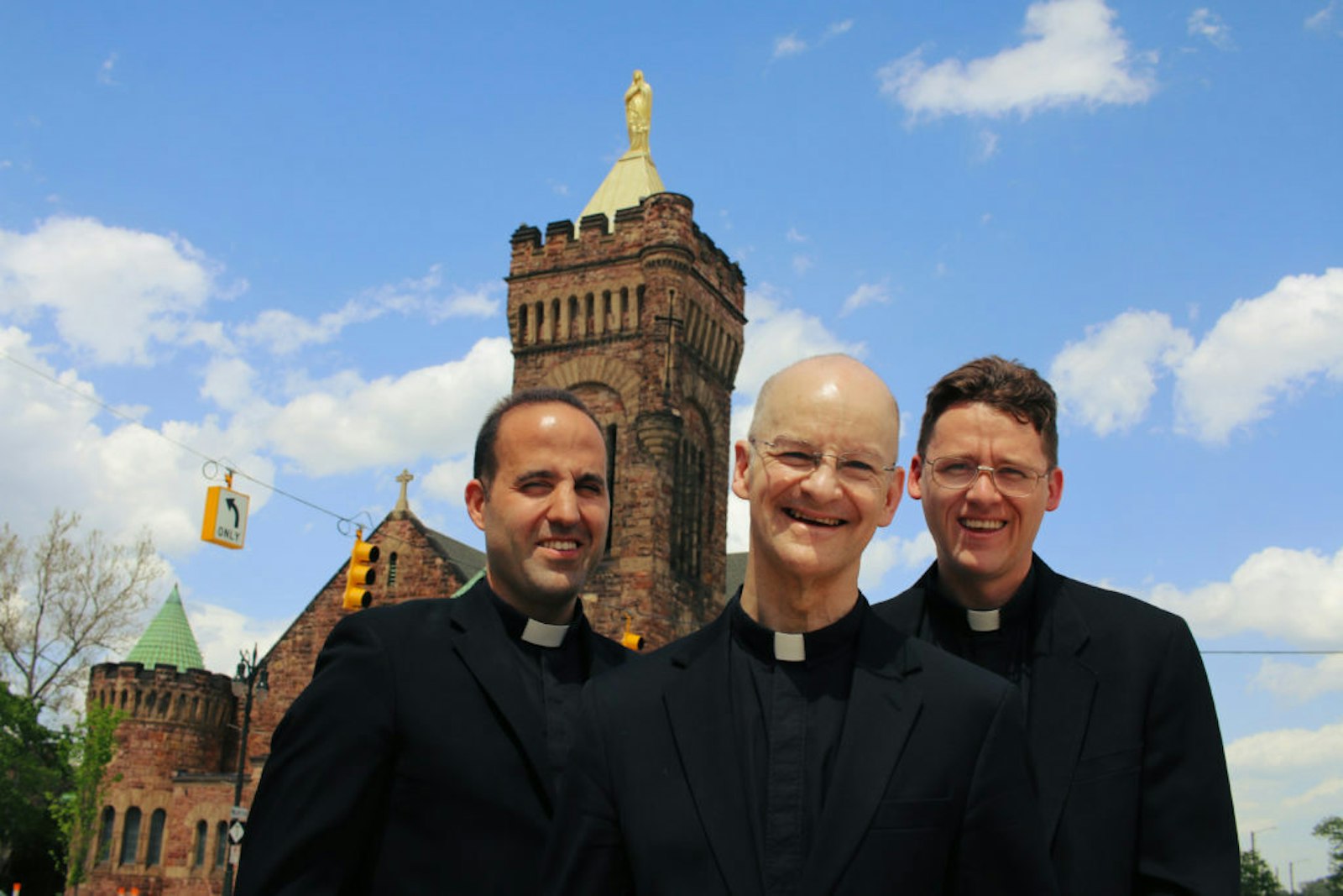 Left to right, Fr. Marko Djonovic, Fr. Daniel Jones and Fr. Ryan Adams are pictured in front of Our Lady of the Rosary Church in Detroit's Midtown in July 2017. The three priests started what was then known as the Detroit Oratory in Formation, an effort that ultimately fizzled. Fr. Jones, who was a driving force behind the effort, died of cancer in 2021. (Detroit Catholic file photo)