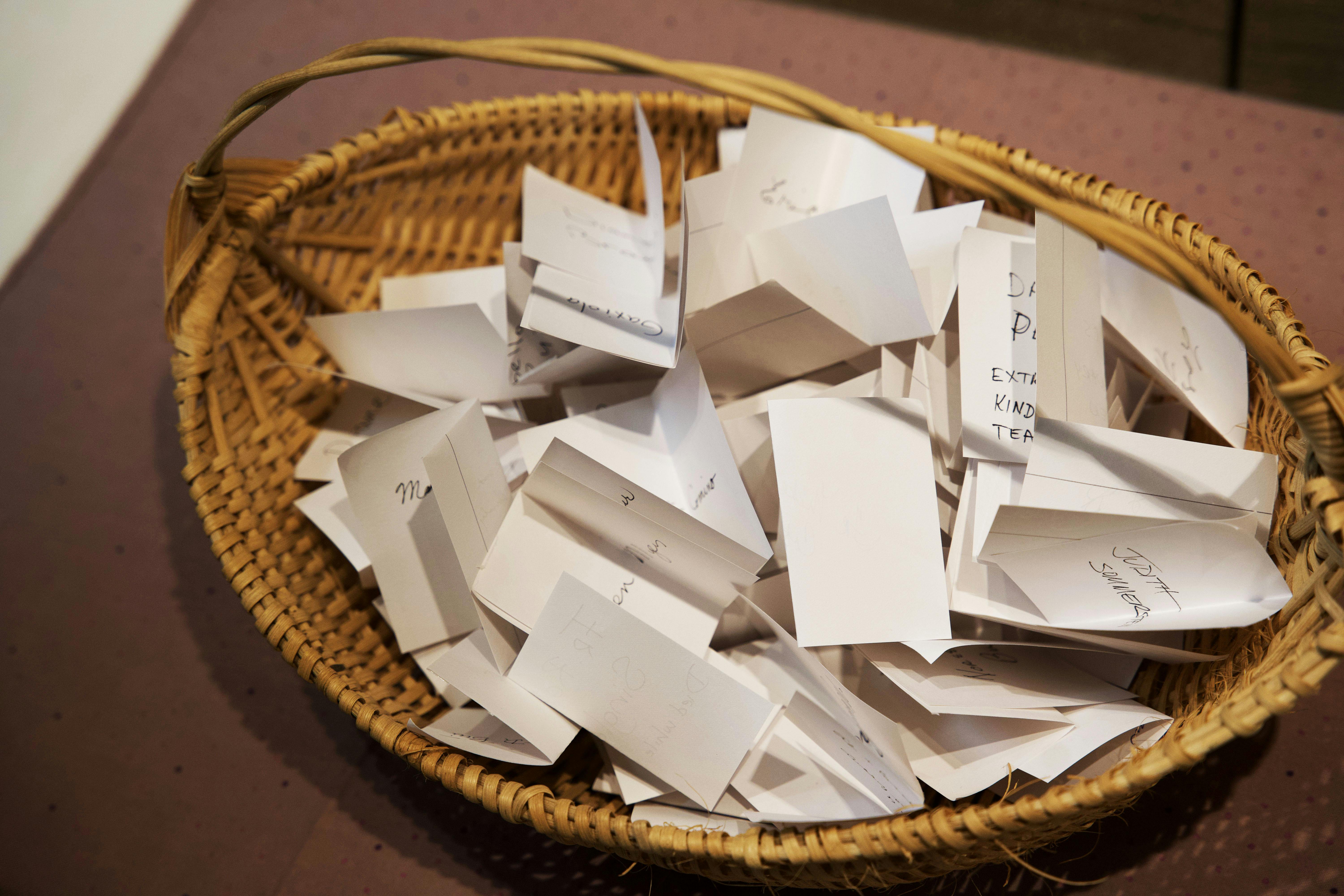 Visitors were invited to write the names of those lost to COVID-19 on a slip of paper and place it in a basket as part of the exhibit.