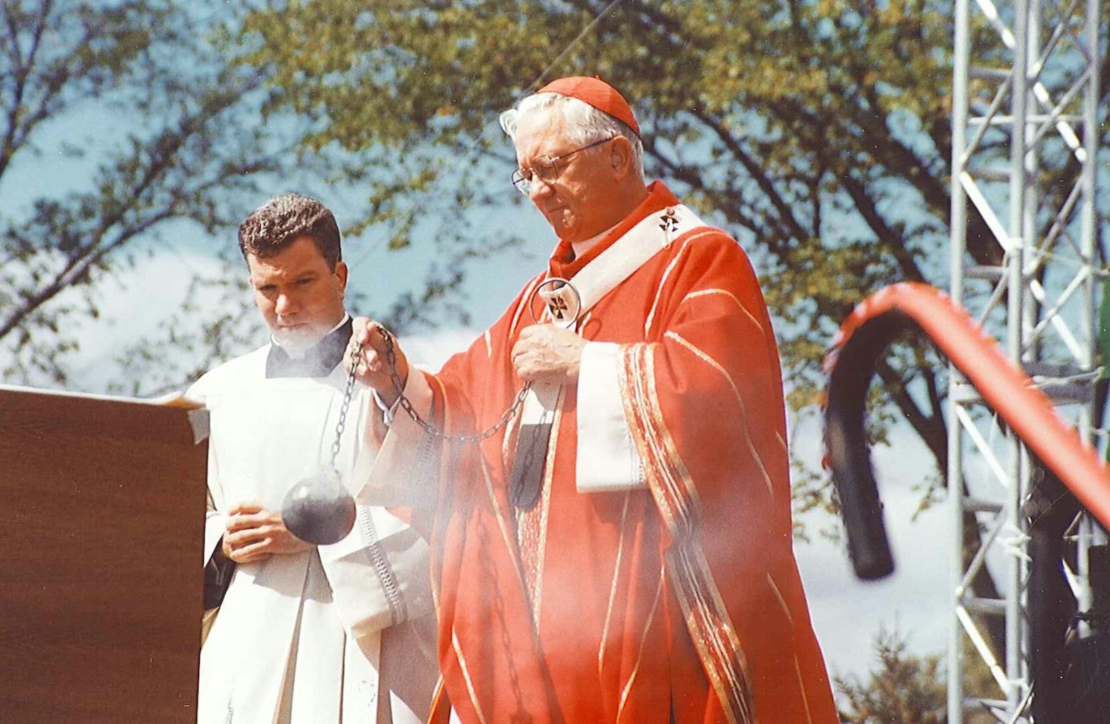 Detroit Cardinal Adam J. Maida celebrates an outdoor Mass at St. John's Center in Plymouth during a Eucharistic Congress in 2000 as then-Fr. Jeffrey M. Monforton, left, assists. Bishop Monforton spent seven years serving as Cardinal Maida's personal priest-secretary from 1998 to 2005, learning the ins and outs of the Archdiocese of Detroit and absorbing valuable lessons about episcopal service. (Larry A. Peplin | Detroit Catholic file photo)
