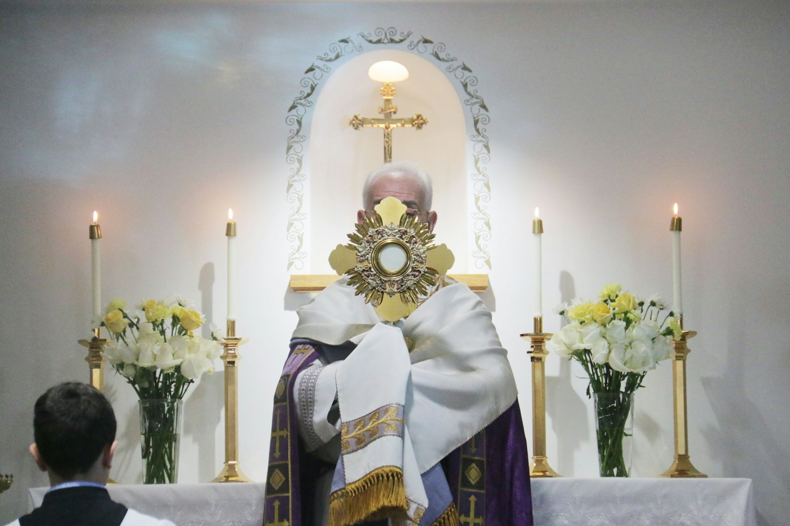 Fr. Cyril Whitaker holds up the monstrance containing the Blessed Sacrament during benediction during a Holy Hour for Ukraine at the Our Lady of Fatima Shrine in Riverview on March 13.