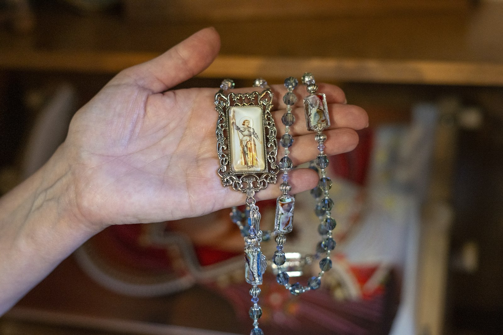 Quesada uses rare beads and chooses the images for each rosary with care before setting them with resin.