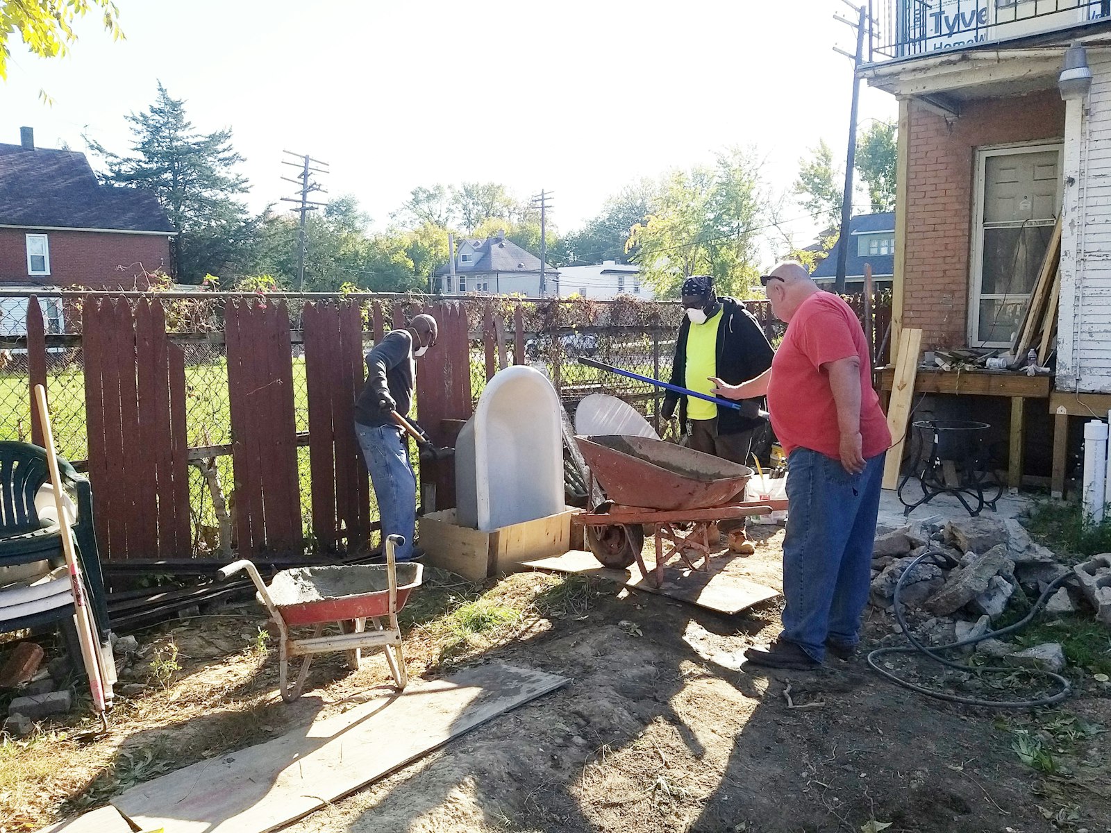 Volunteers and workers build a niche for a Marian grotto.