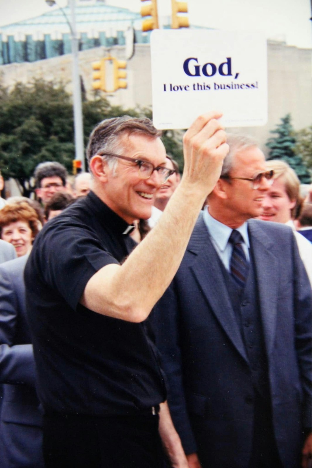 Fr. Prus holds a sign outside of the National Shrine of the Little Flower Basilica in Royal Oak in this undated photo. (Courtesy of Father Ed Prus Facebook page)