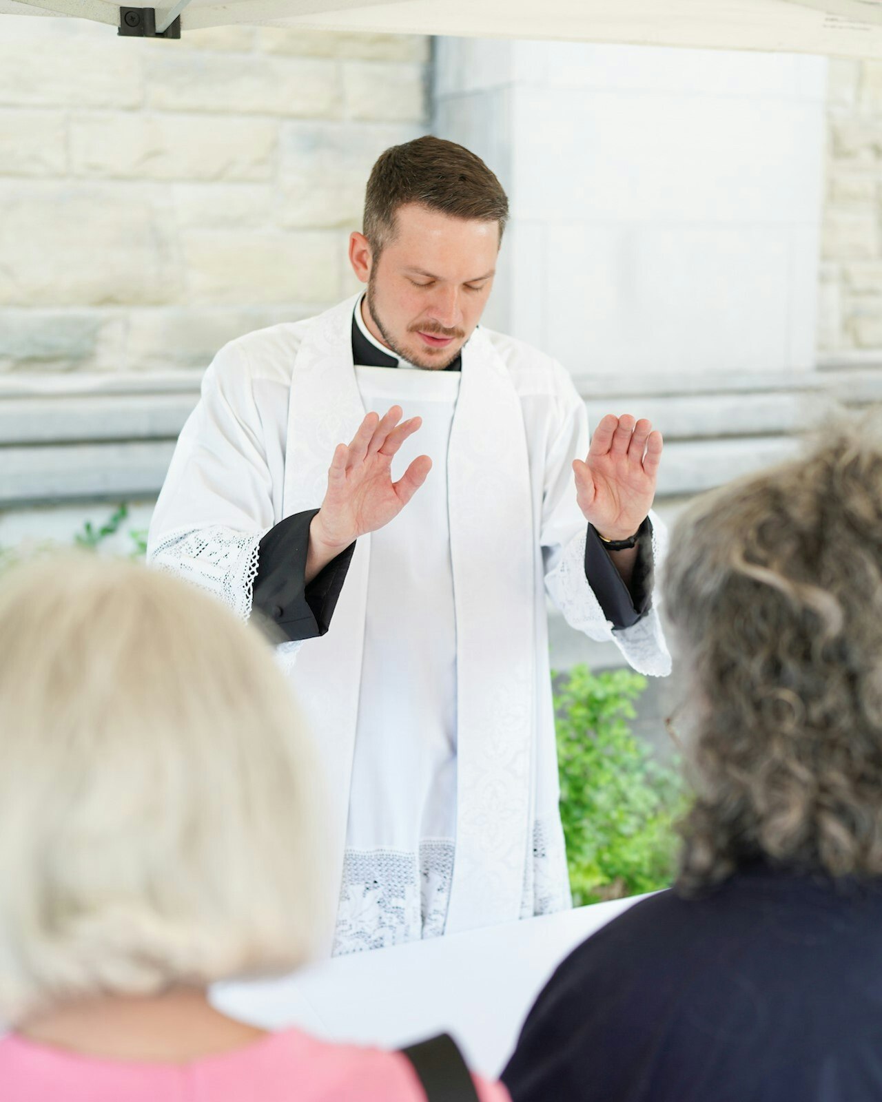 Fr. Ryan Walters prays over friends, family and well-wishers after the ordination Mass.