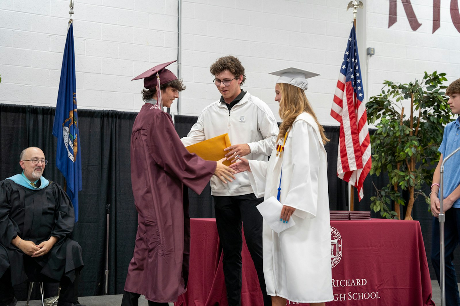 Isabella Chiles, right, and her brothers Robbie and Jacob present the inaugural Robert and Christine Chiles Foundation Scholarship, in honor of their late parents, to 2024 graduate Christopher Kowalsky.