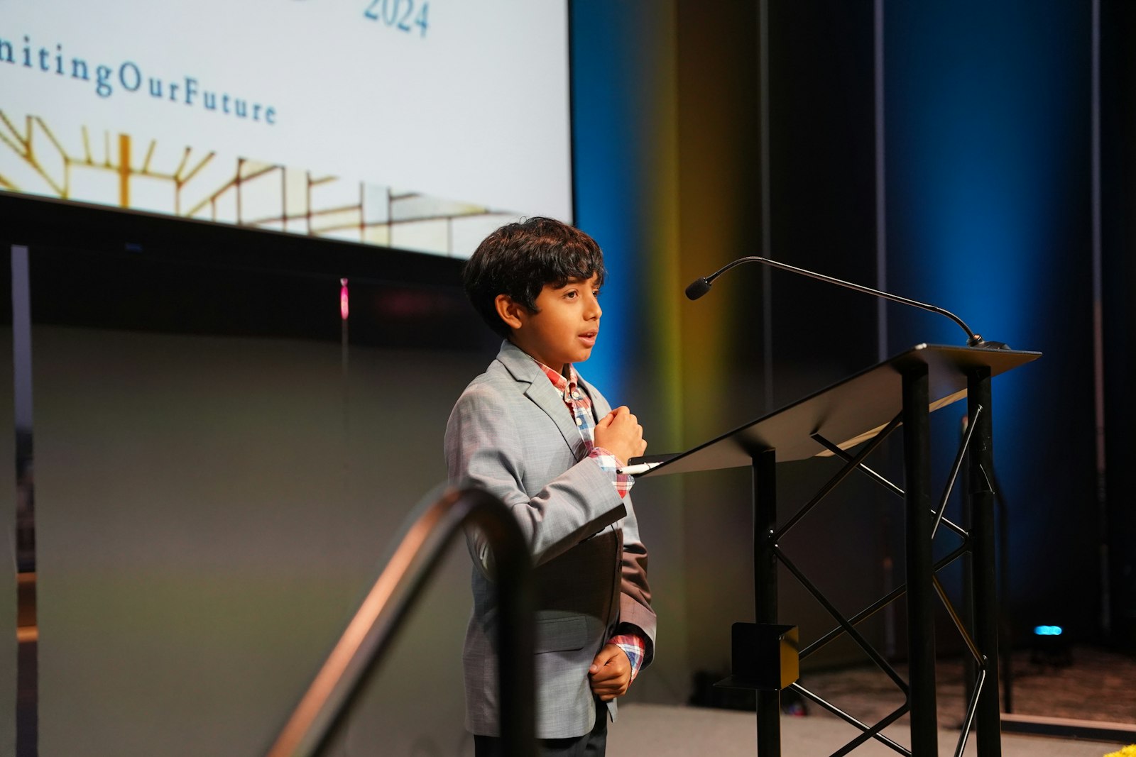 Mateo Pulido, a seventh-grader at Most Holy Redeemer School in Detroit, leads a prayer before dinner at the gala. Pulido was one of the students who received a scholarship from Detroit Archbishop Allen H. Vigneron and Chris Allen, director of the board at the Catholic Foundation of Michigan, earlier this year.