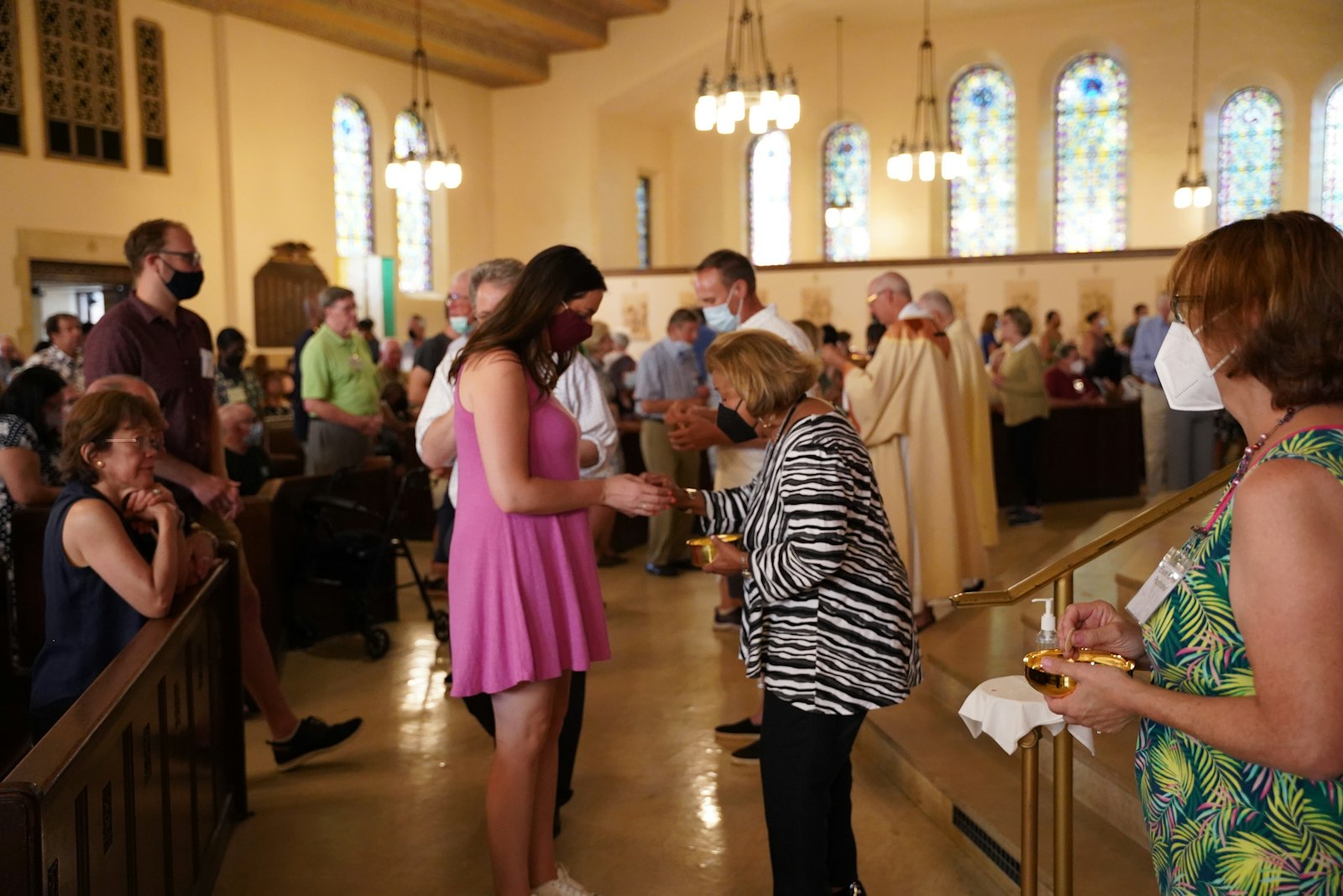 An extraordinary minister of holy Communion distributes Communion at Mass during the Gesu centennial celebration. Gesu parishioners often bring up the parish’s welcoming nature and involvement in the community as reasons why their parish stands out.