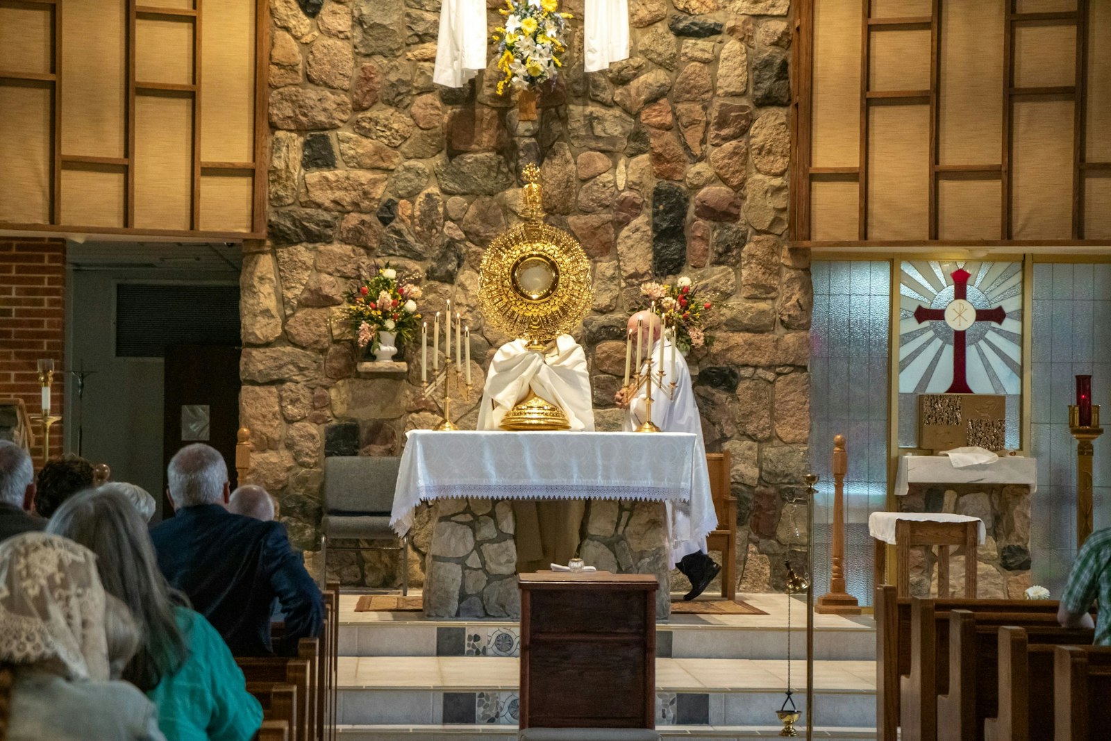 Fr. Sama Muma, associate pastor of SS. Peter and Paul Parish, elevates the monstrance to bless worshippers during the May 6 Eucharistic Revival. The five-foot-tall monstrance was commissioned as a gift for a priest in the Diocese of Toledo, who has offered to lend it to parishes in Michigan and Ohio for Eucharistic events.