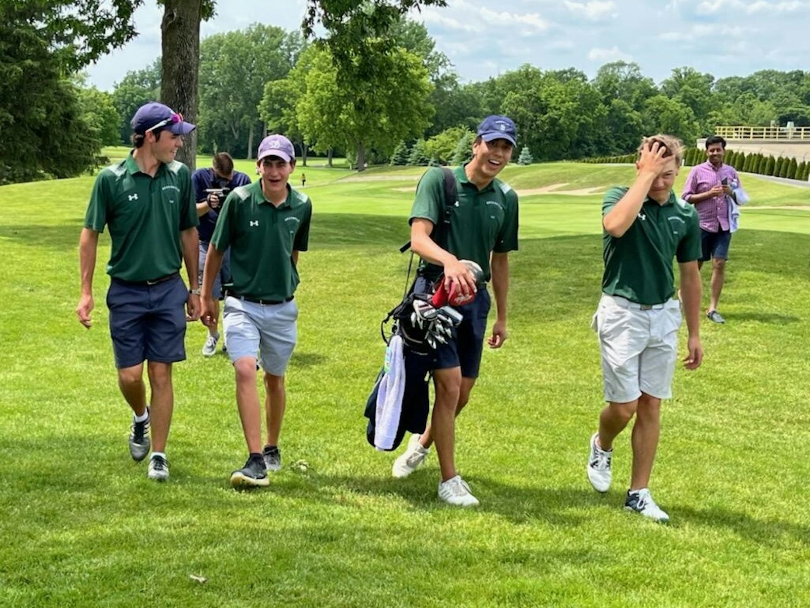 Golfers from Ann Arbor Greenhills, including medalist Cale Piedmonte-Lang (second from left), walk back to the clubhouse after learning they had won the Division 3 state title – the Gryphons’ first since 1994. (Photo by Keith Dunlap | Special to Detroit Catholic)