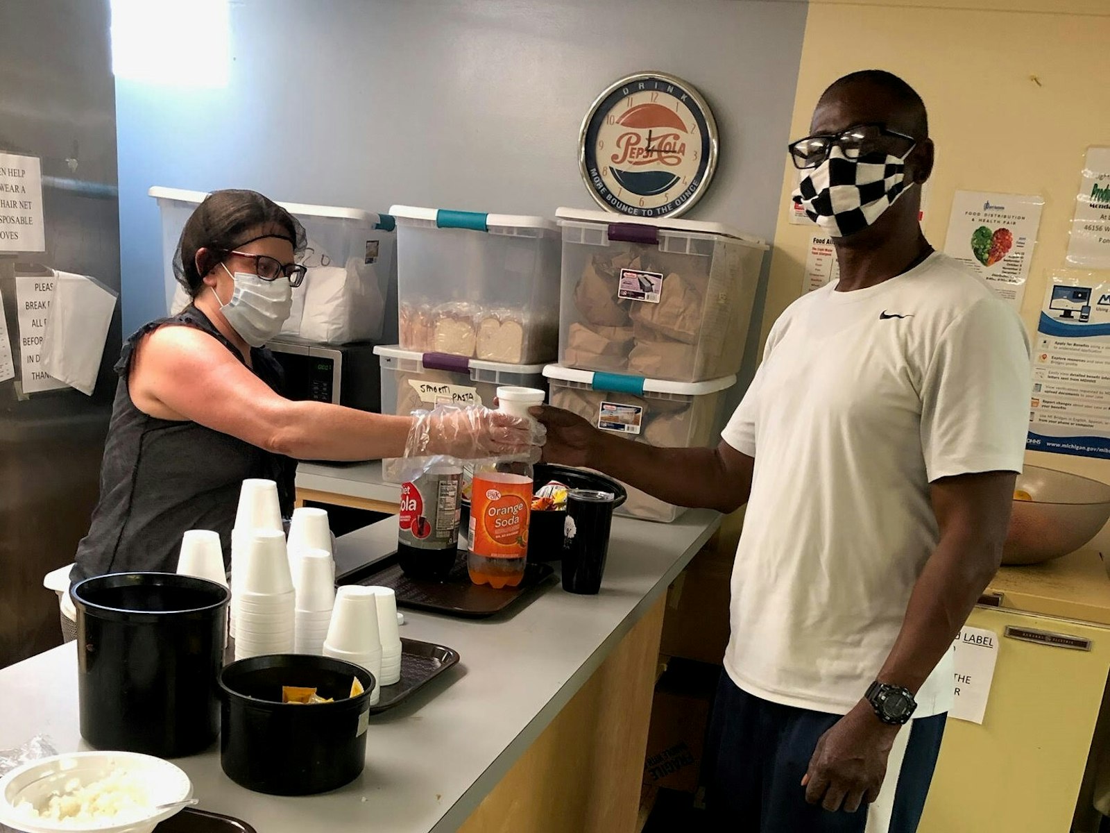 A HOPE Shelters volunteer serves a meal to a guest at its Pontiac kitchen. Each year, the shelter serves approximately 400 individuals. (Courtesy of Brian Wright)