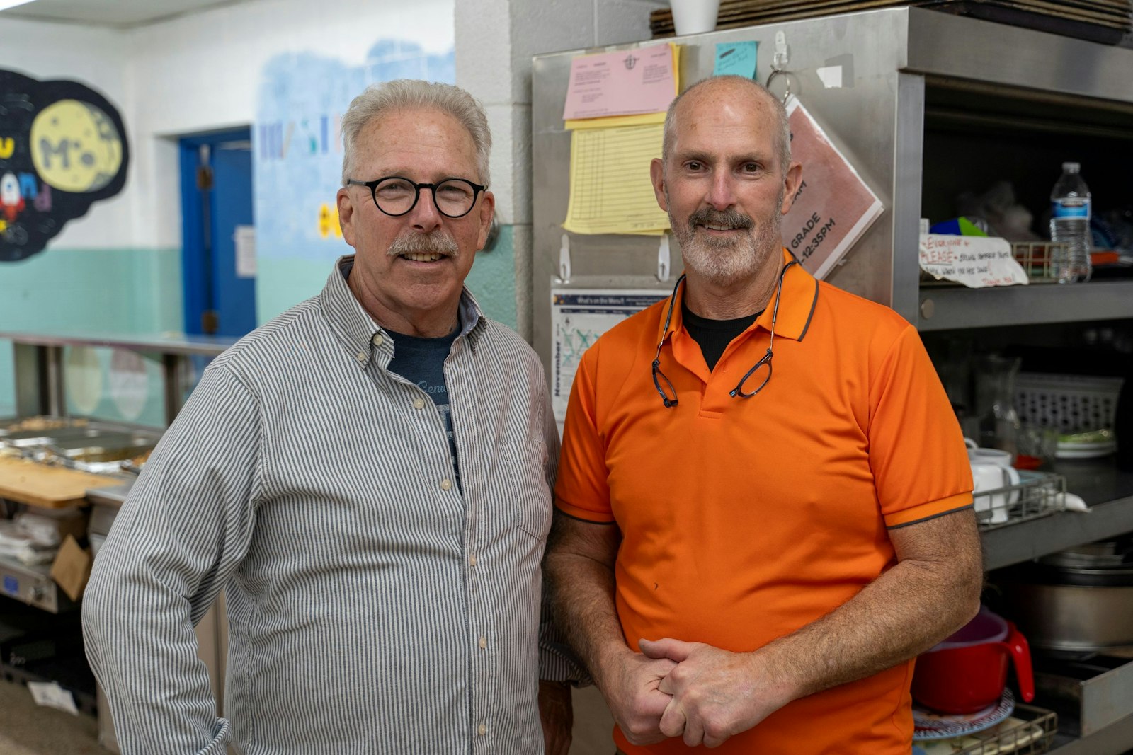 Dan Murphy, left, stands with his brother, Tim Murphy in the kitchen at Most Holy Trinity School in Detroit, where family, parish members and volunteers put on a Thanksgiving meal for 130 men and women on Nov. 23. In 2015, Dan Murphy founded a nonprofit, Corktown Blessings, to raise money for the annual event. (Valaurian Waller | Detroit Catholic)