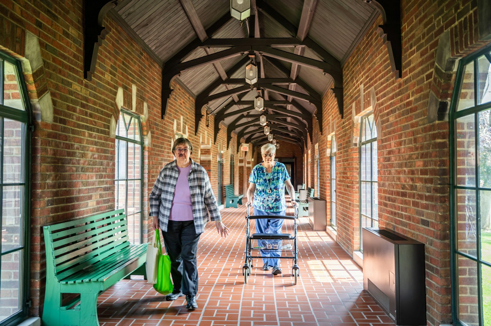 Two sisters are pictured walking the halls of the Sisters, Servants of the Immaculate Heart of Mary's motherhouse in August 2023. In June 2024, the IHM Sisters announced the congregation had entered an “option to purchase agreement” with developer KM Cornerstone to begin the possible redevelopment of the historic former St. Mary’s Academy site. (Valaurian Waller | Detroit Catholic)