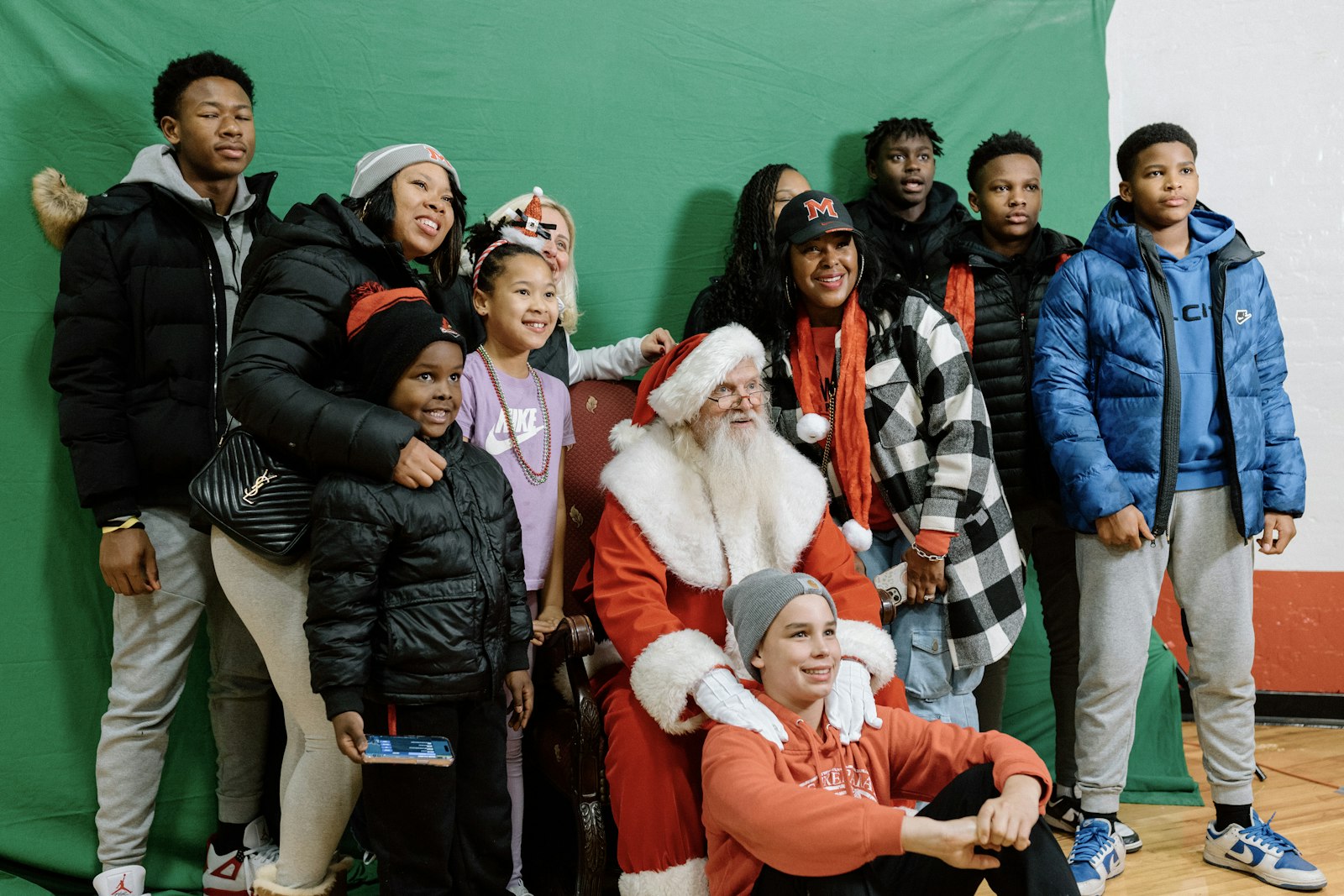 Families pose for photos with Santa Claus during the Orchard Lake Schools' annual "Mingle All the Way" celebration Nov. 19. (Alissa Tuttle | Special to Detroit Catholic)