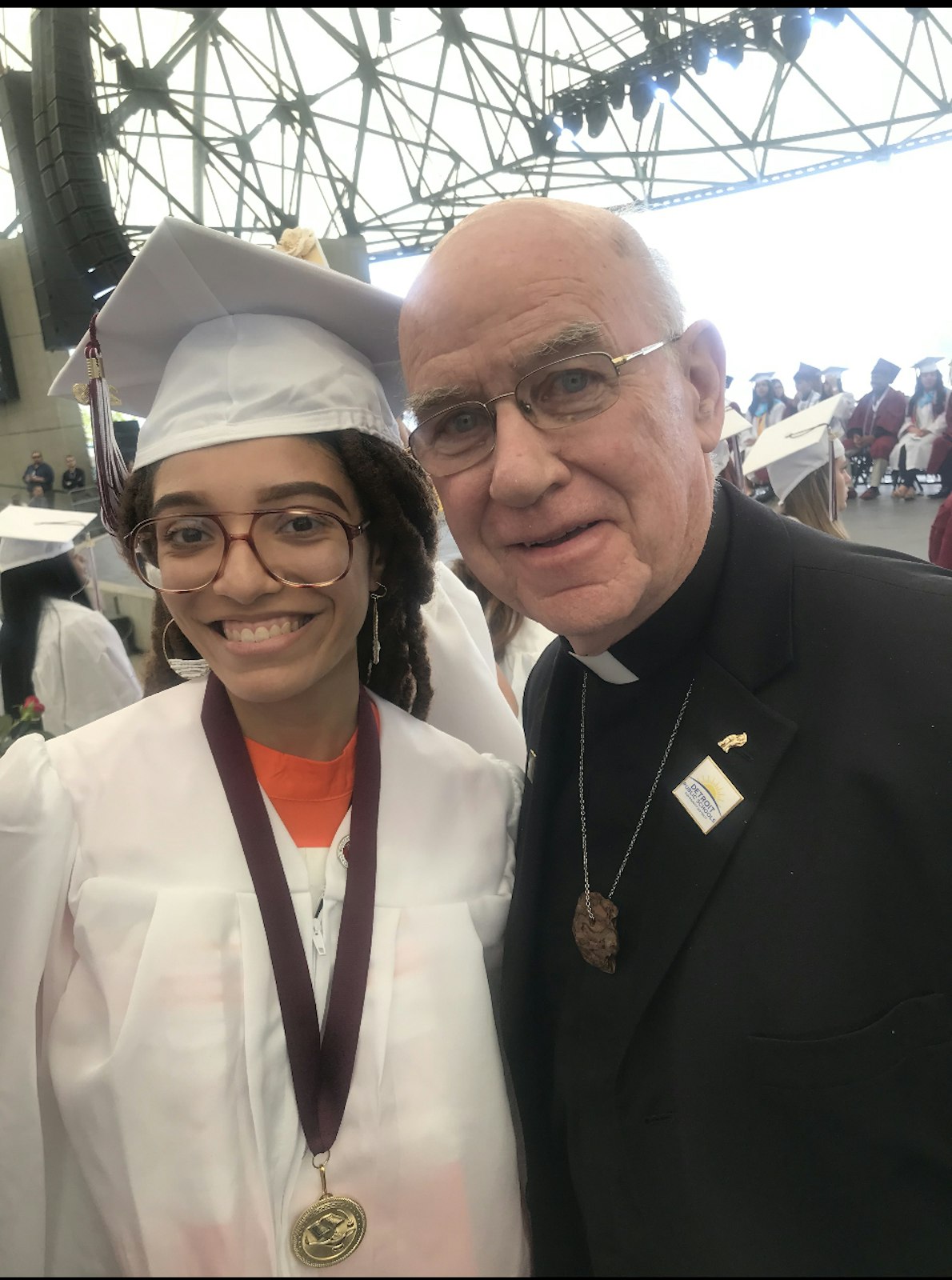 Fr. John Phelps, C.Ss.R., one of the co-founders of Life Directions, poses with a young person who found success through Life Directions and graduated high school. (Photo courtesy of Life Directions)