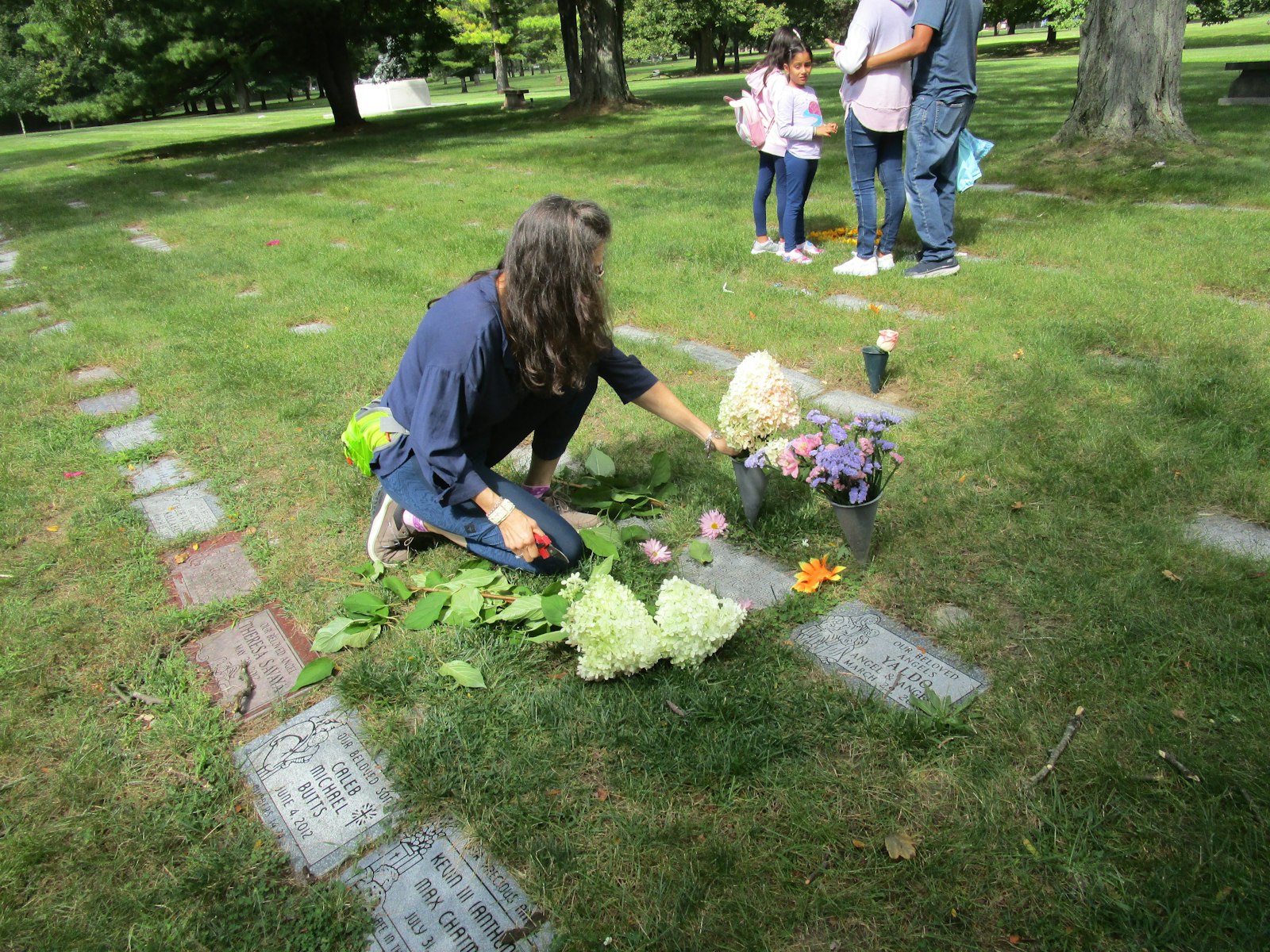 A woman honors the victims of abortion at the grave where 23 aborted babies are buried in Holy Sepulchre Cemetery in Southfield. (Courtesy of Citizens for a Pro-Life Society)