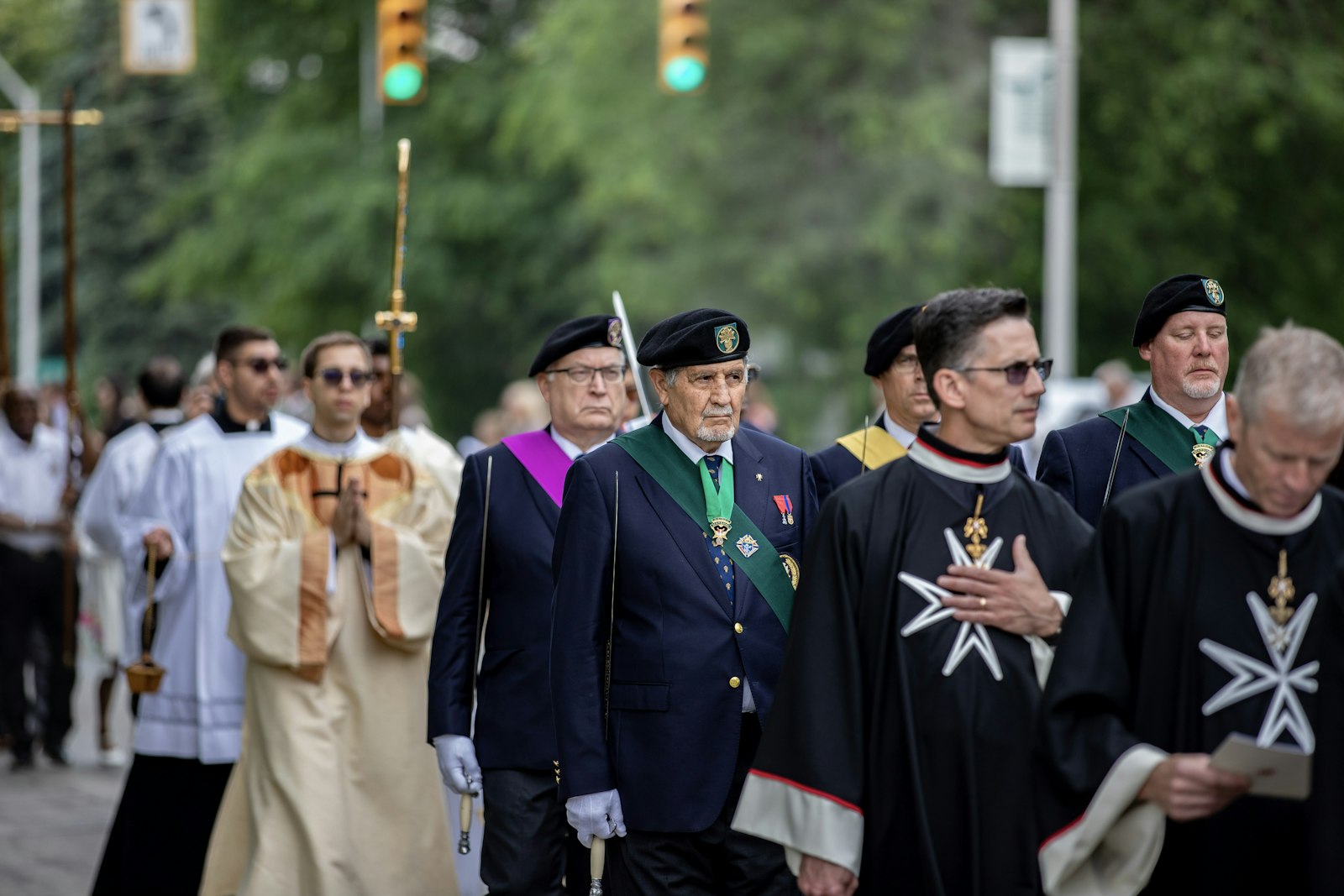 Members of the Knights and Dames of the Order of Malta, the Knights and Ladies of St. Peter Claver and the Knights of Columbus process in full regalia during the Eucharistic procession outside the cathedral. (Alissa Tuttle | Special to Detroit Catholic)