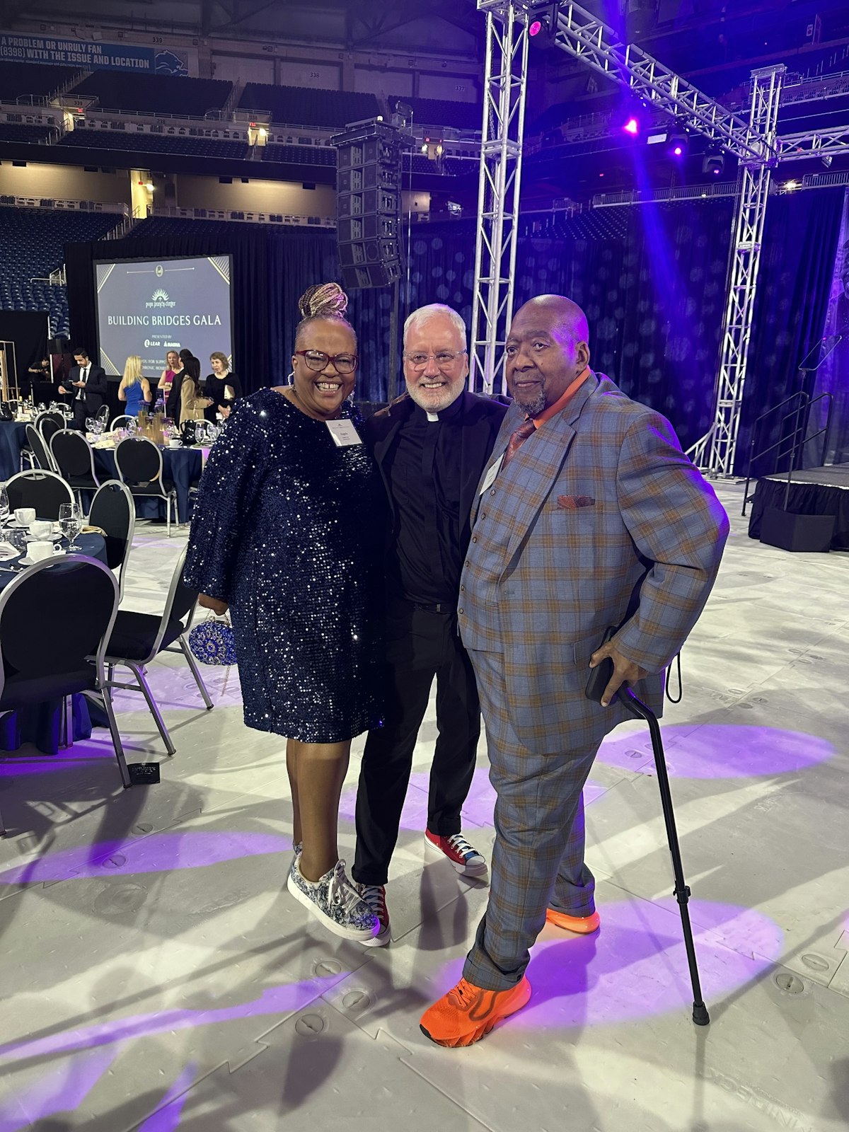 From left to right, Angela Vann, Fr. Tim McCabe, SJ, and Arnold Vann smile during the Pope Francis Center's "Building Bridges Gala" on April 11.