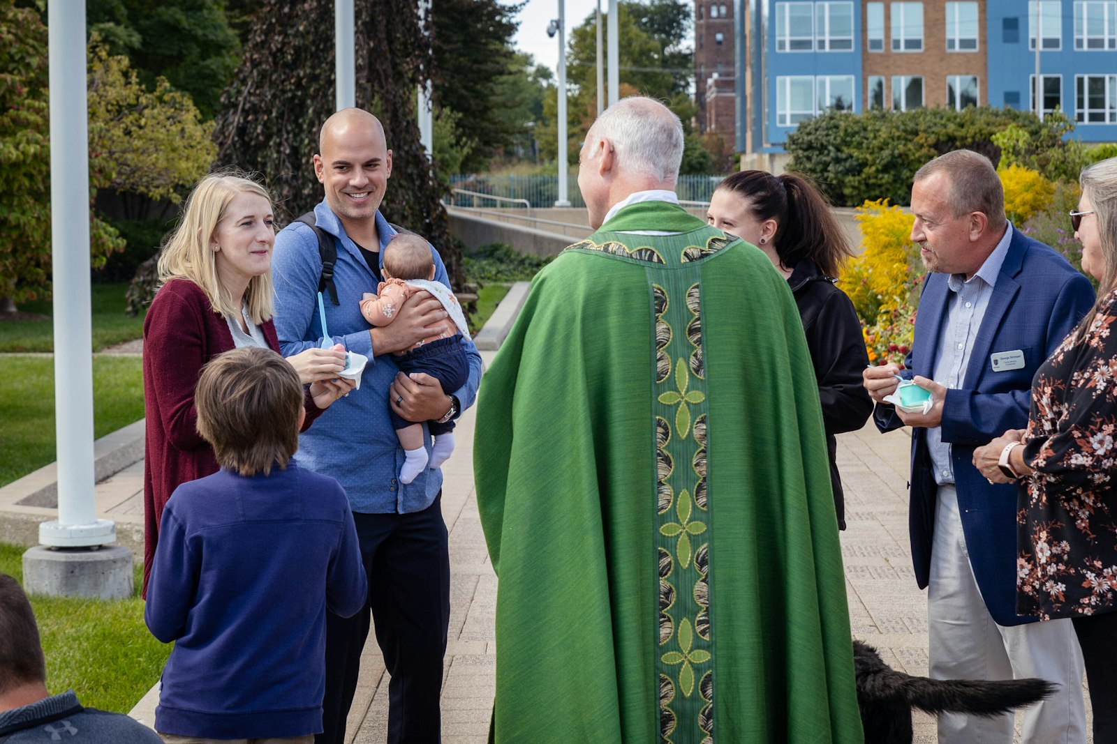 Fr. Mech greets families after Mass in the cathedral's plaza, where ice cream was served as families congregated for fellowship in honor of grandparents' unique roles.