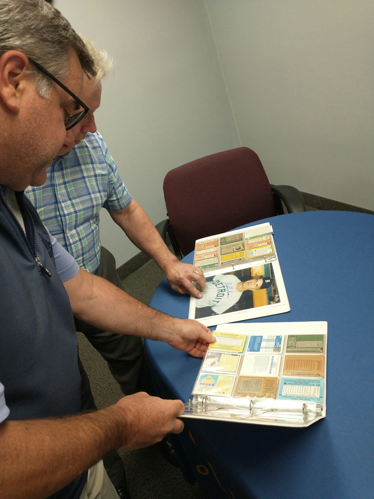 Paul Propson, CEO of Catholic Charities of Southeast Michigan, looks at some of the photos and baseball cards donated by Deacon Nick Curran for Catholic Charities' fall gala Sept. 15. (Courtesy of Catholic Charities of Southeast Michigan)