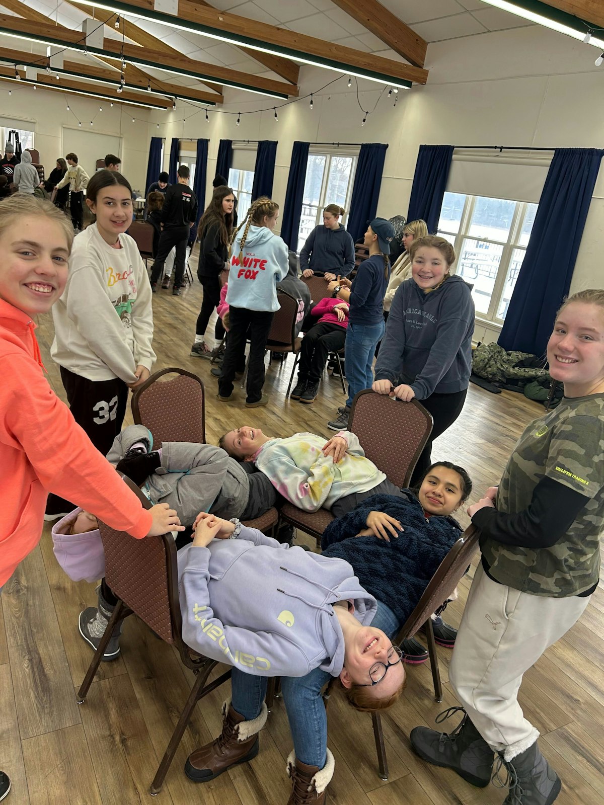 Young people play games inside the retreat center at Our Lady of the Fields Camp. The camp, which includes 218 acres with a shrine, lakefront views and spaces for group activities. (Photos courtesy of Our Lady of the Fields Camp)