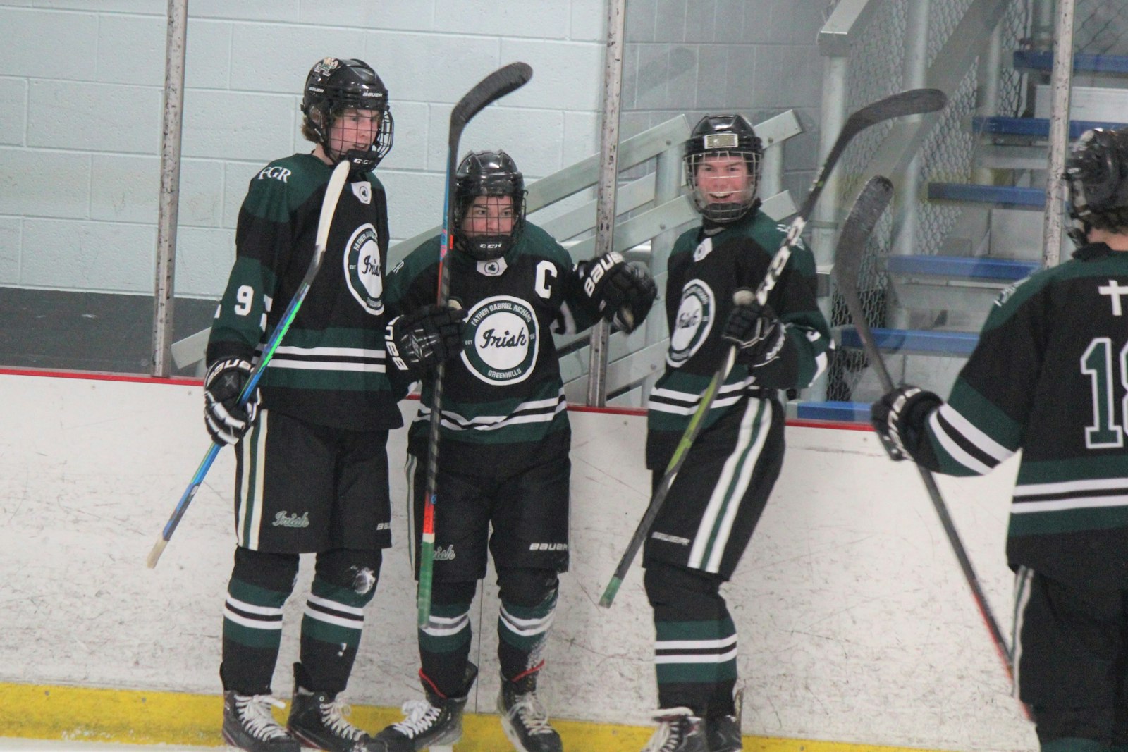 Ryan Kowalchik, Jack Waldo and Griffin White celebrate Waldo’s first-period goal for Ann Arbor Fr. Gabriel Richard.