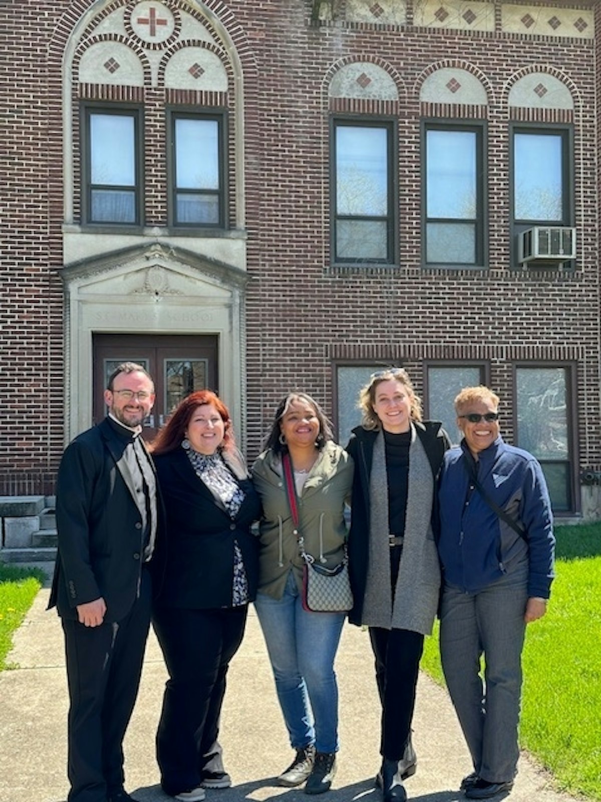 Fr. Athanasius Fornwalt, FHS, left, administrator of St. Mary of Redford Parish, said he was impressed by Volunteers of America’s “built-in ethic that’s concerned about the whole person.” The supportive housing project is modeled after similar efforts at St. Matthew and St. John Paul II parishes in Detroit in recent years.