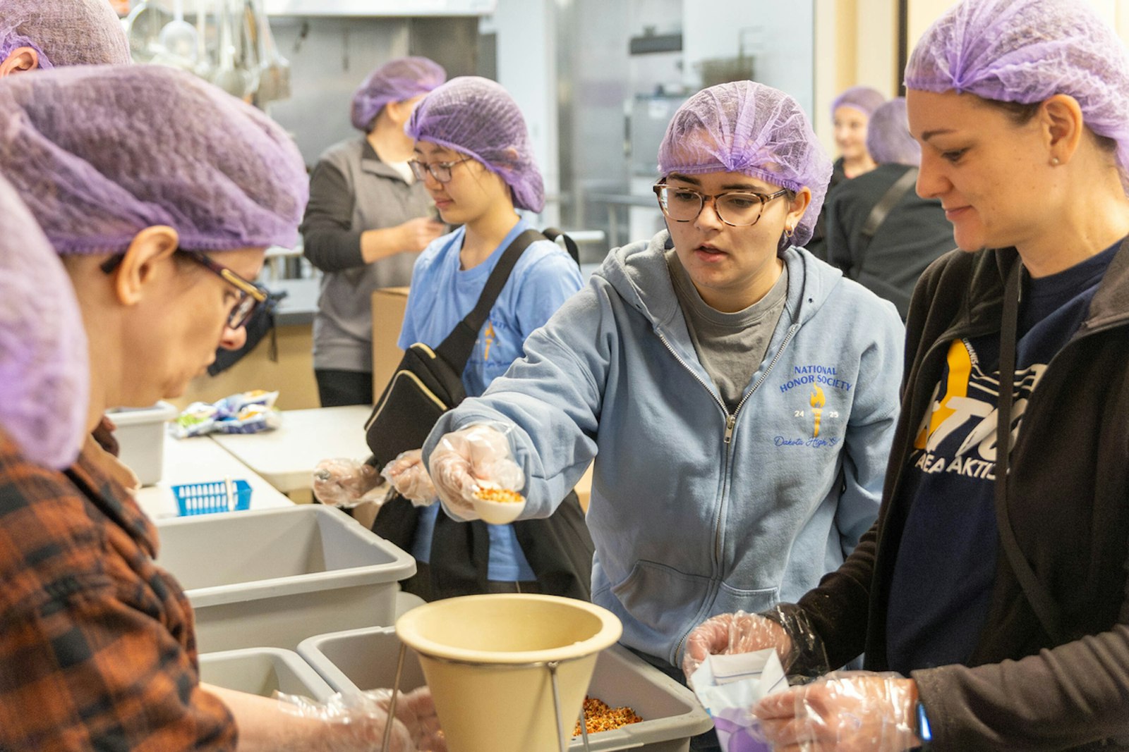 High school students from nearby schools such as Dakota High School and Austin Catholic High School were among hundreds of volunteers who joined the effort on a Saturday morning.