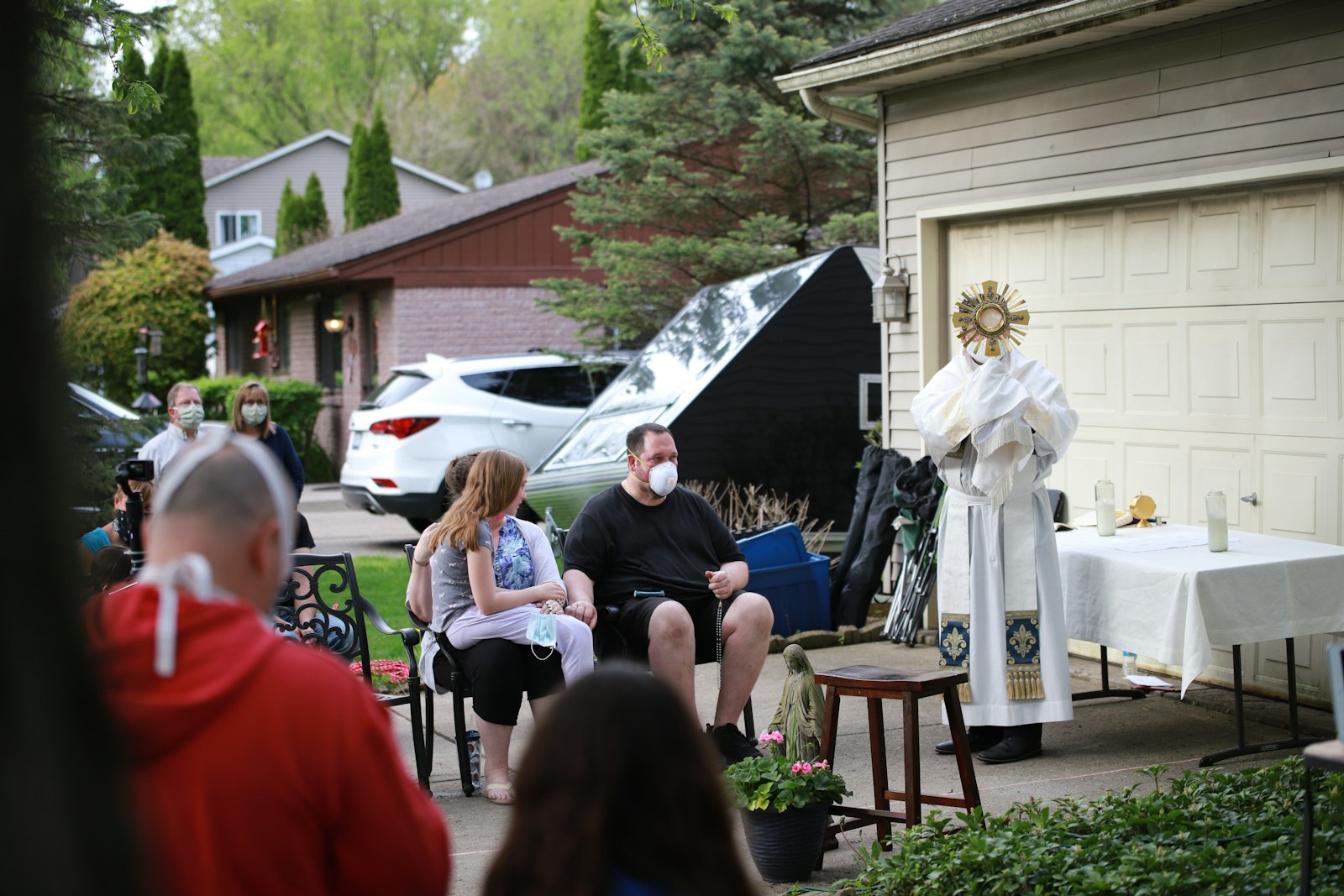 Fr. Mark Livingston elevates the monstrance with Jesus in the Blessed Sacrament during an outdoor adoration and benediction at the Cavanaughs' home in the spring of 2020.