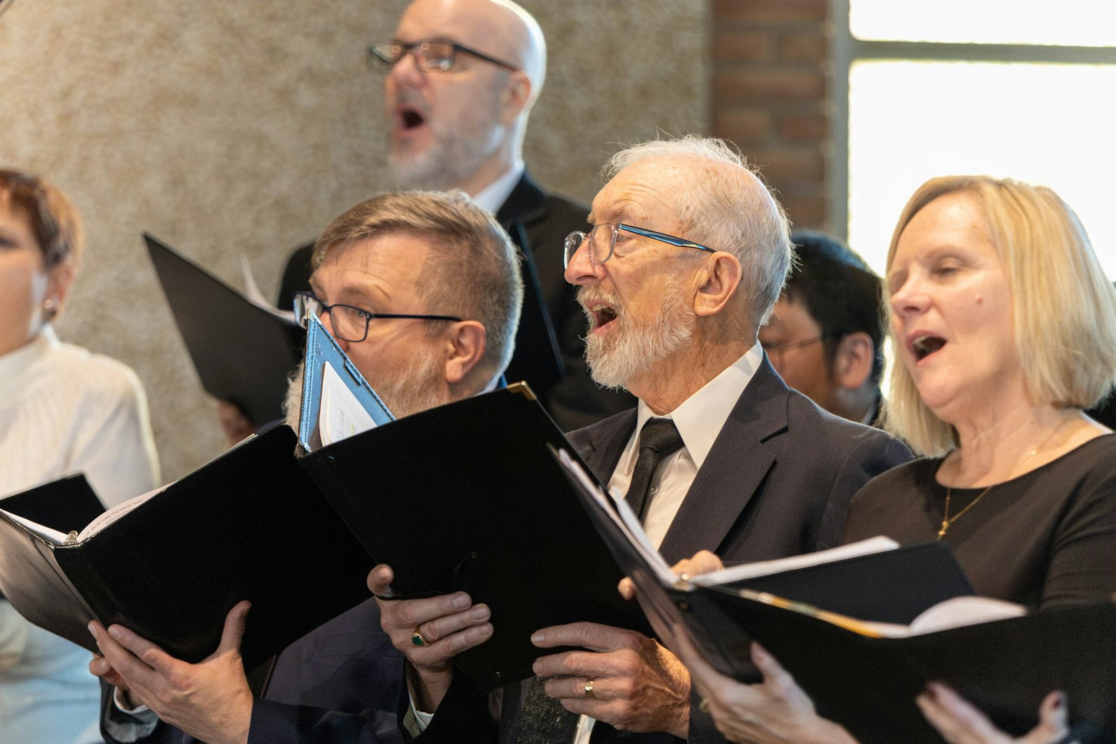 Choir members sing in harmony during the 100th anniversary celebration of Our Lady of La Salette Parish in Berkley.