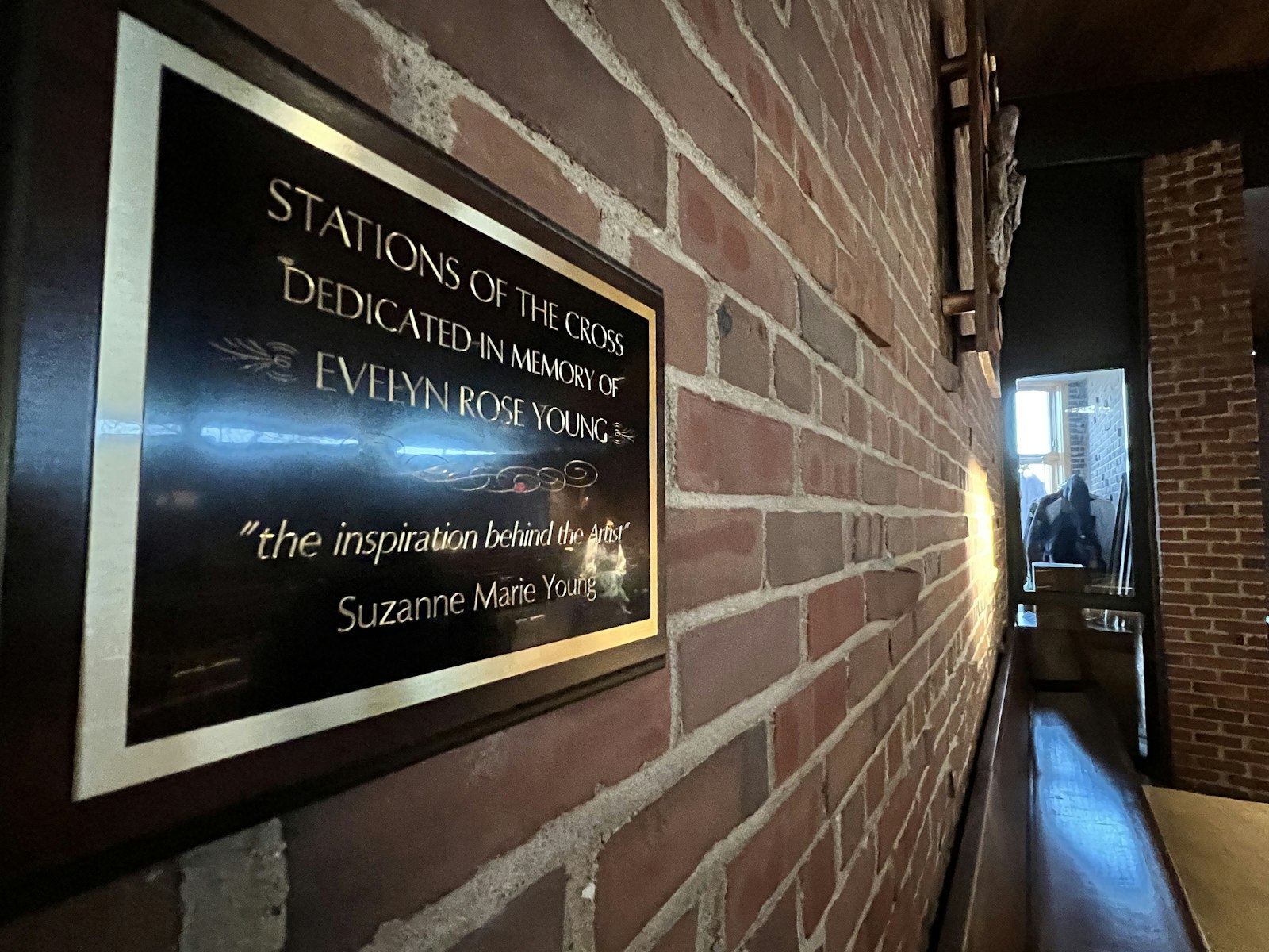 A plaque hangs near the Stations of the Cross at St. John Fisher Chapel University Parish in Auburn Hills dedication the stations to Young's mother, Evelyn Rose Young, who passed away in 2020. (Michael Stechschulte | Detroit Catholic)
