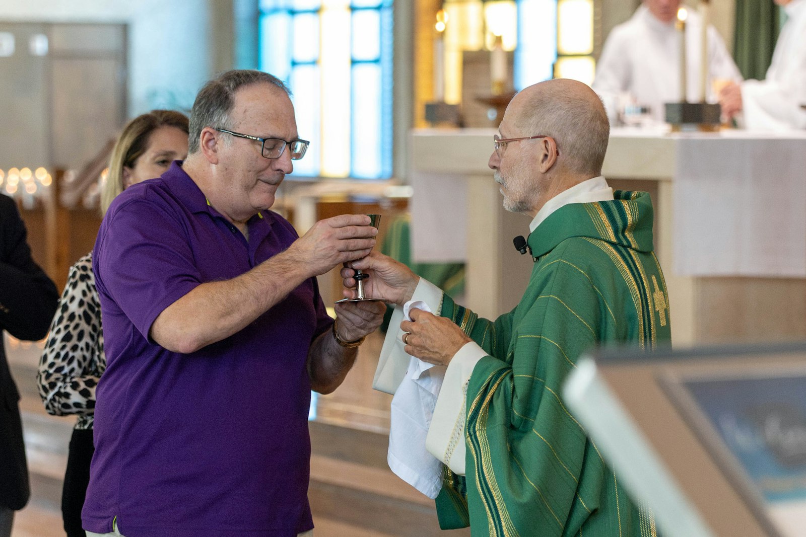 Parishioners receive Communion at the conclusion of the centennial Mass at Our Lady of La Salette.