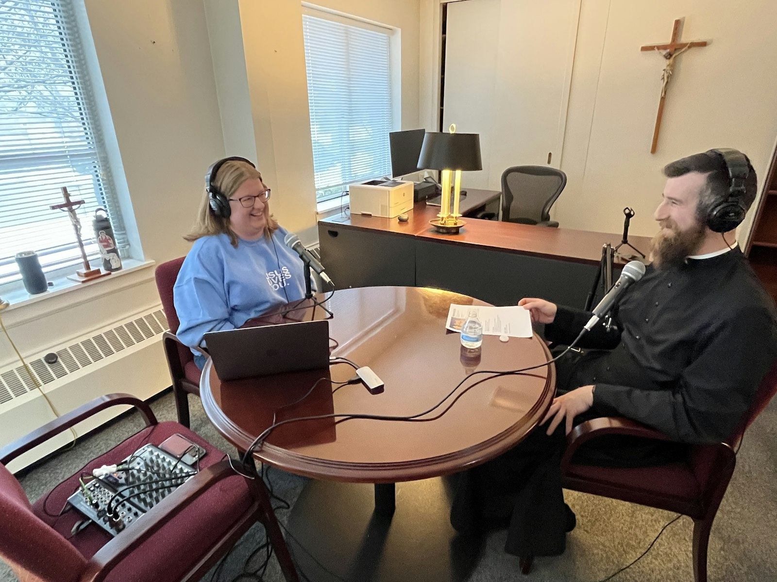 Tori Polhill, left, director of youth discipleship at Our Lady of Sorrows, records an episode of "Seek What's Above" with Fr. Derik Peterman. (Karla Dorweiler | Special to Detroit Catholic)