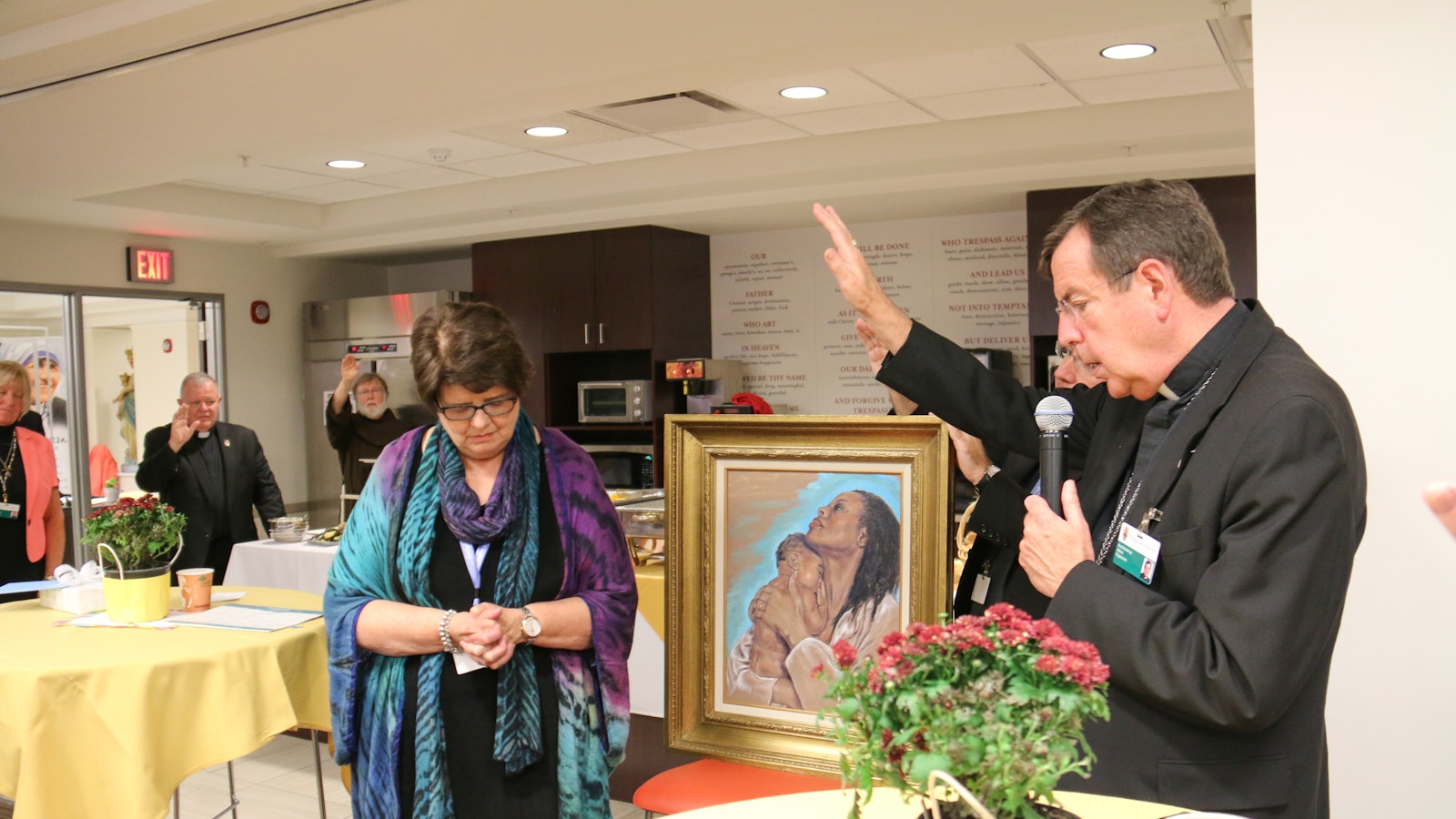 Archbishop Vigneron prays over Pam Beech, human resources director for the Archdiocese of Detroit, during Beech's retirement celebration on Sept. 15, 2016. (Jonathan Francis | Detroit Catholic file photo)