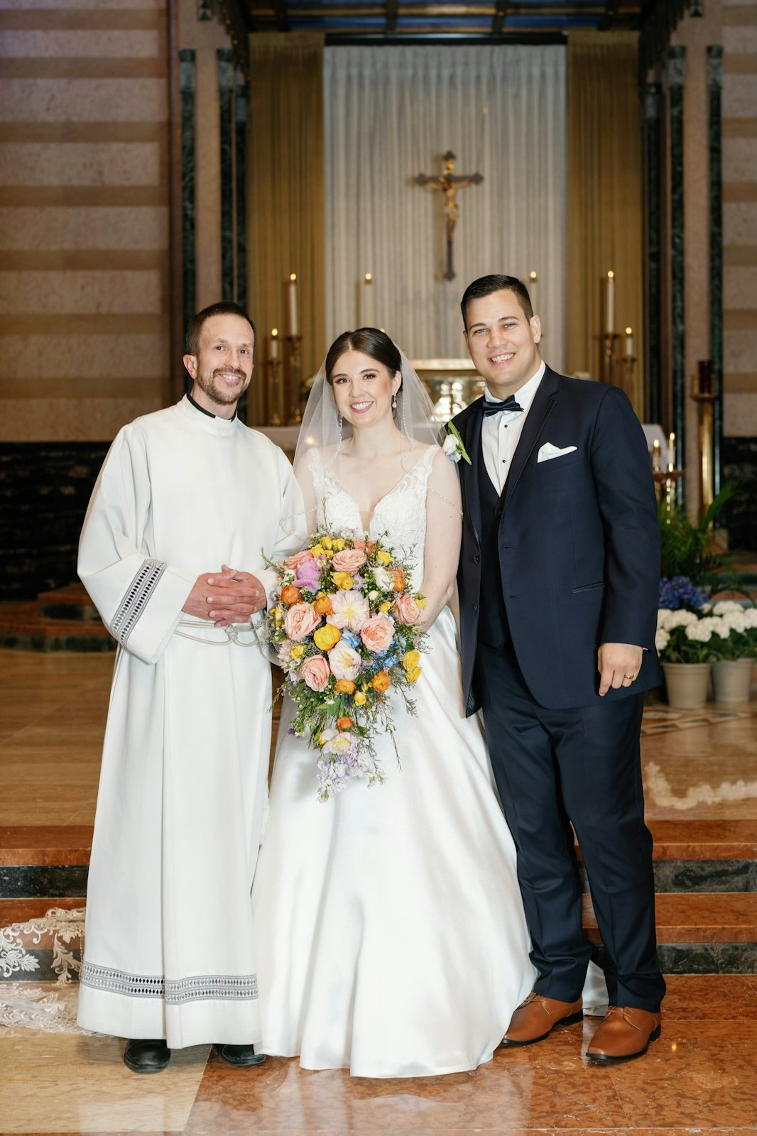 Fr. Snyder is pictured with Ben and Margaret Diaz during their wedding day. Fr. Snyder is currently preparing 43 couples for marriage at St. Mary's, saying wedding preparation "is a beautiful opportunity" to walk with couples in faith.